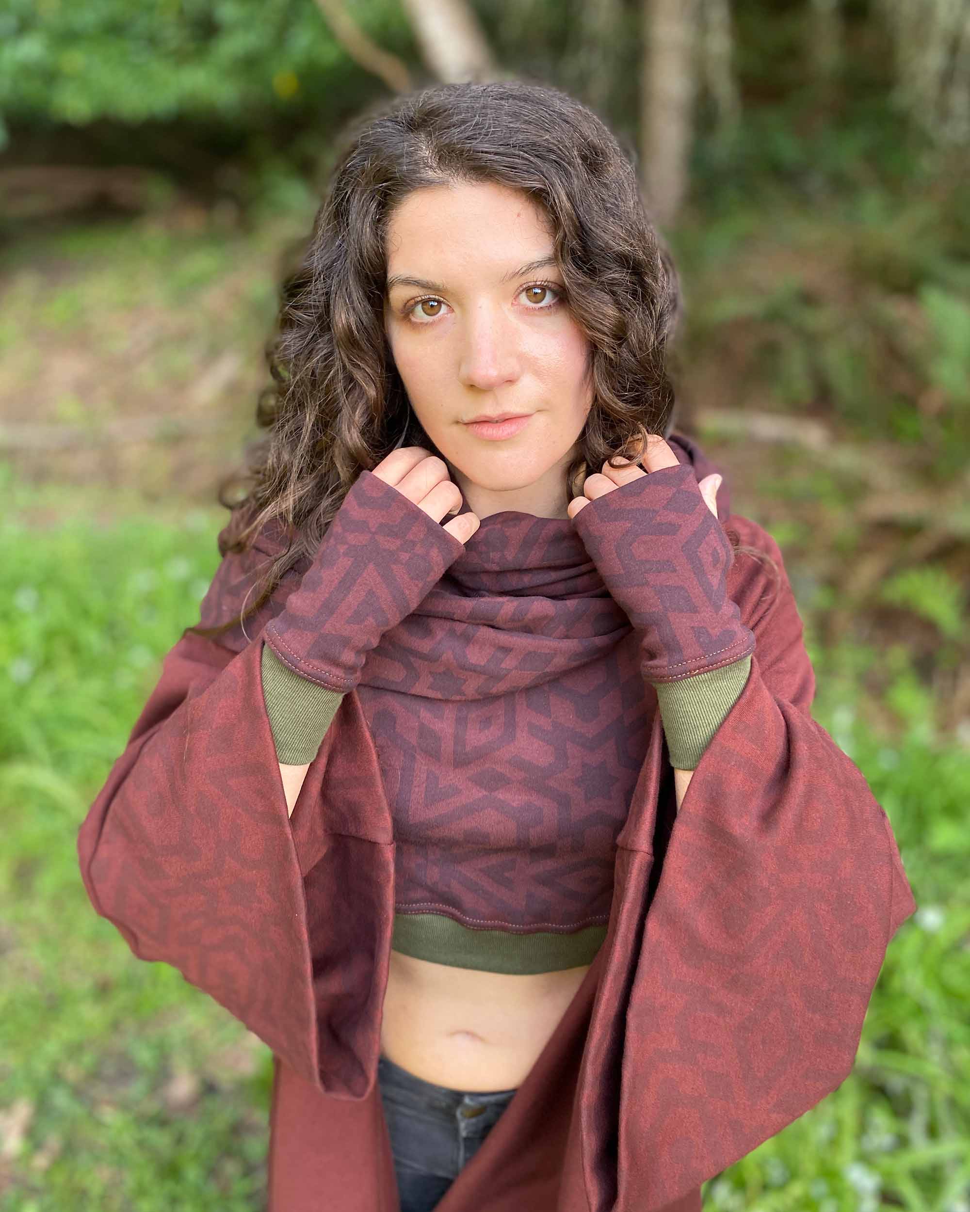 Organic cotton hand warmers, kimono, crop top and scarf in matching reddish brown colored fabric with geometric print, front view.