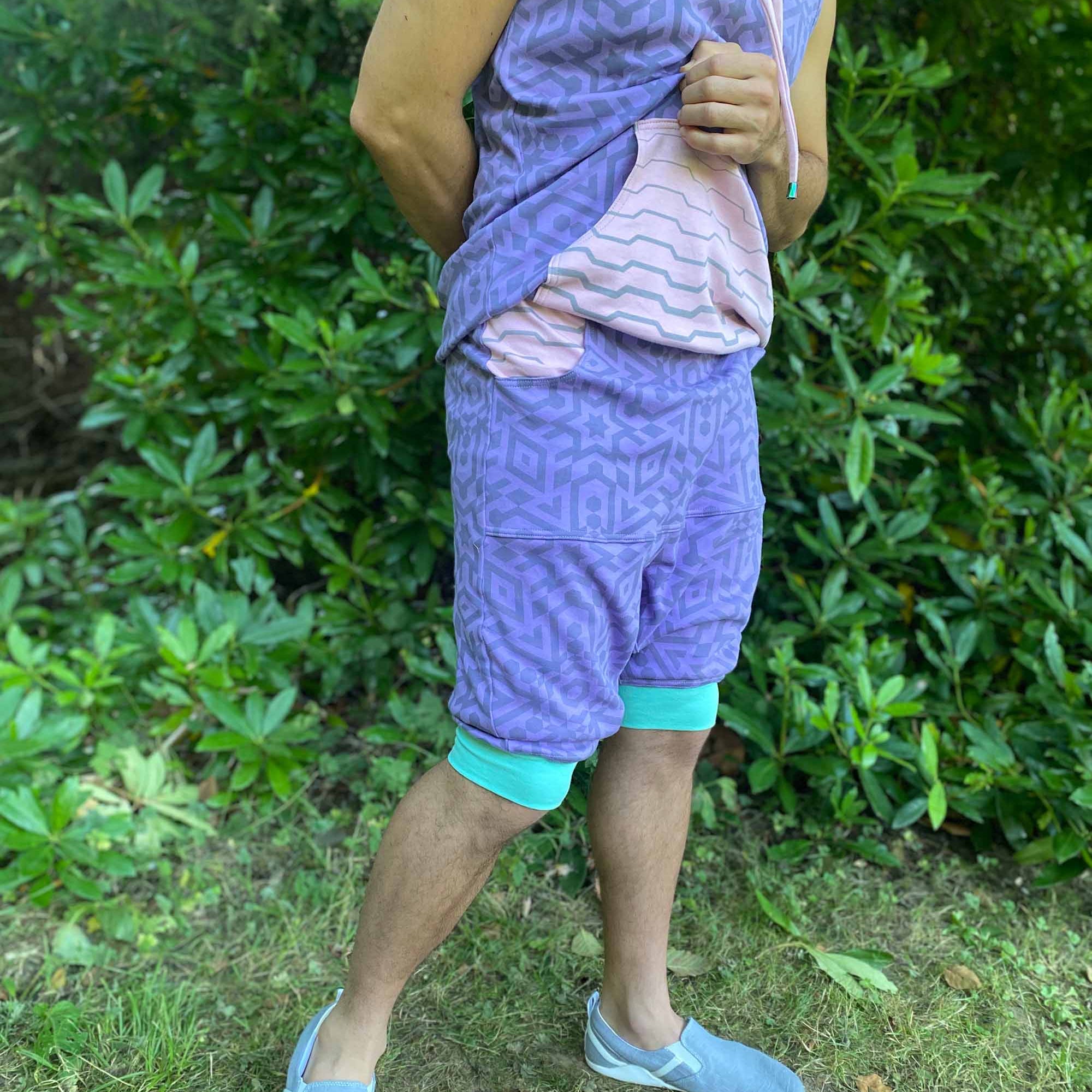 Organic cotton hooded tank top and shorts, lavender fabric with geometric print, right side view on model.