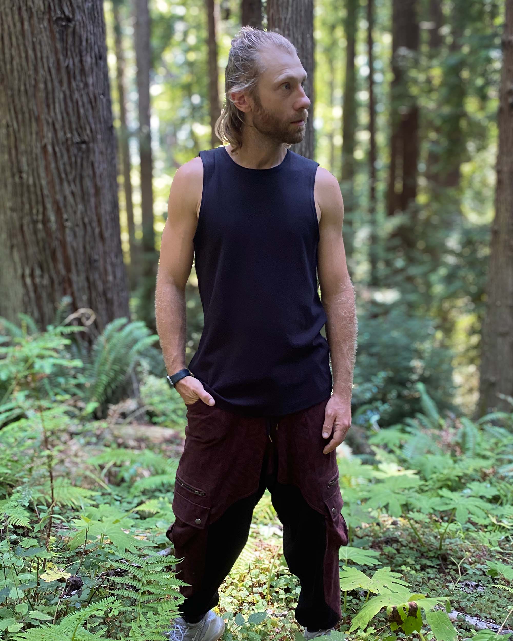 Organic cotton mens tank top, black fabric, right side view on model.