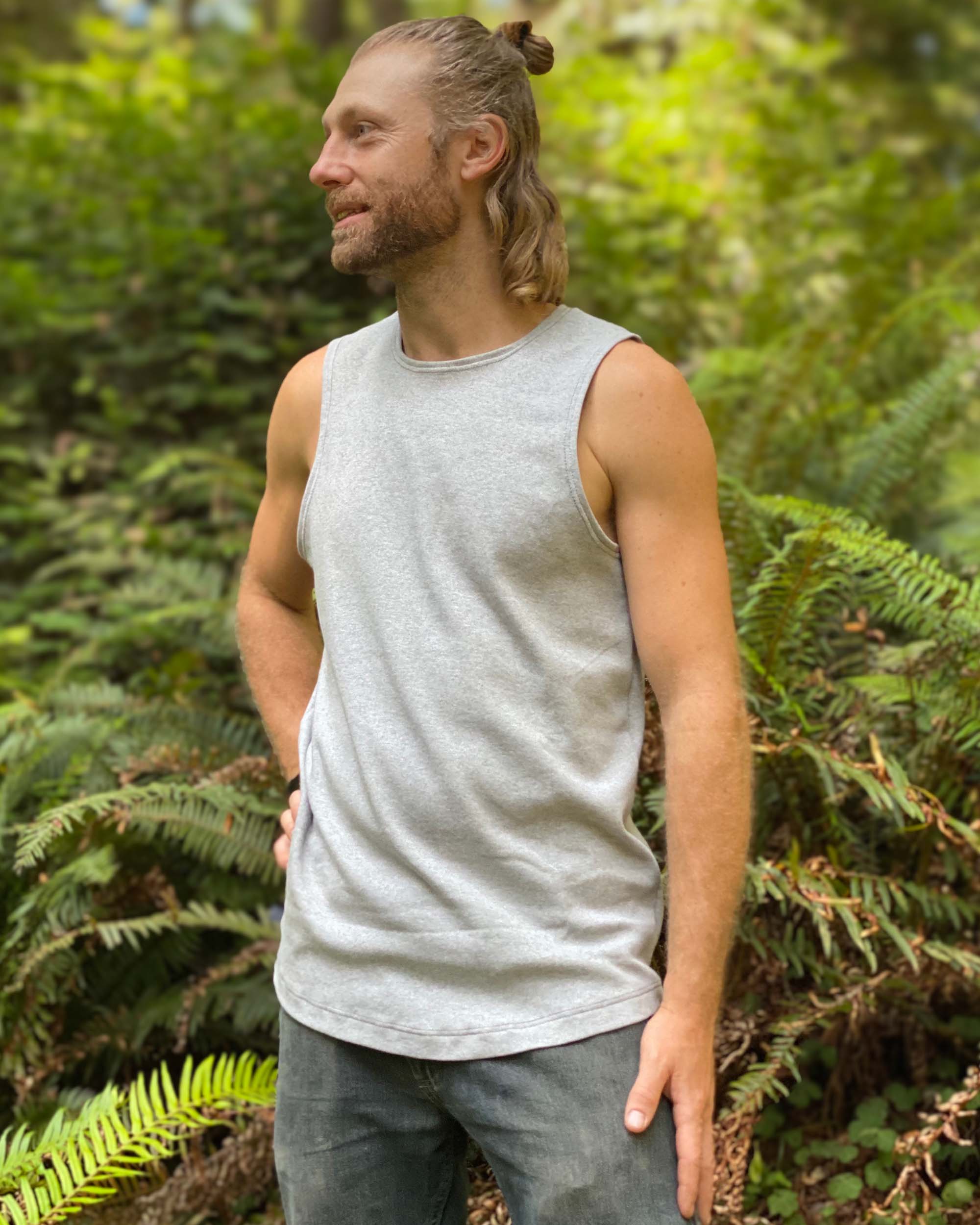 Organic cotton mens tank top, grey fabric, left side view, natural lighting.