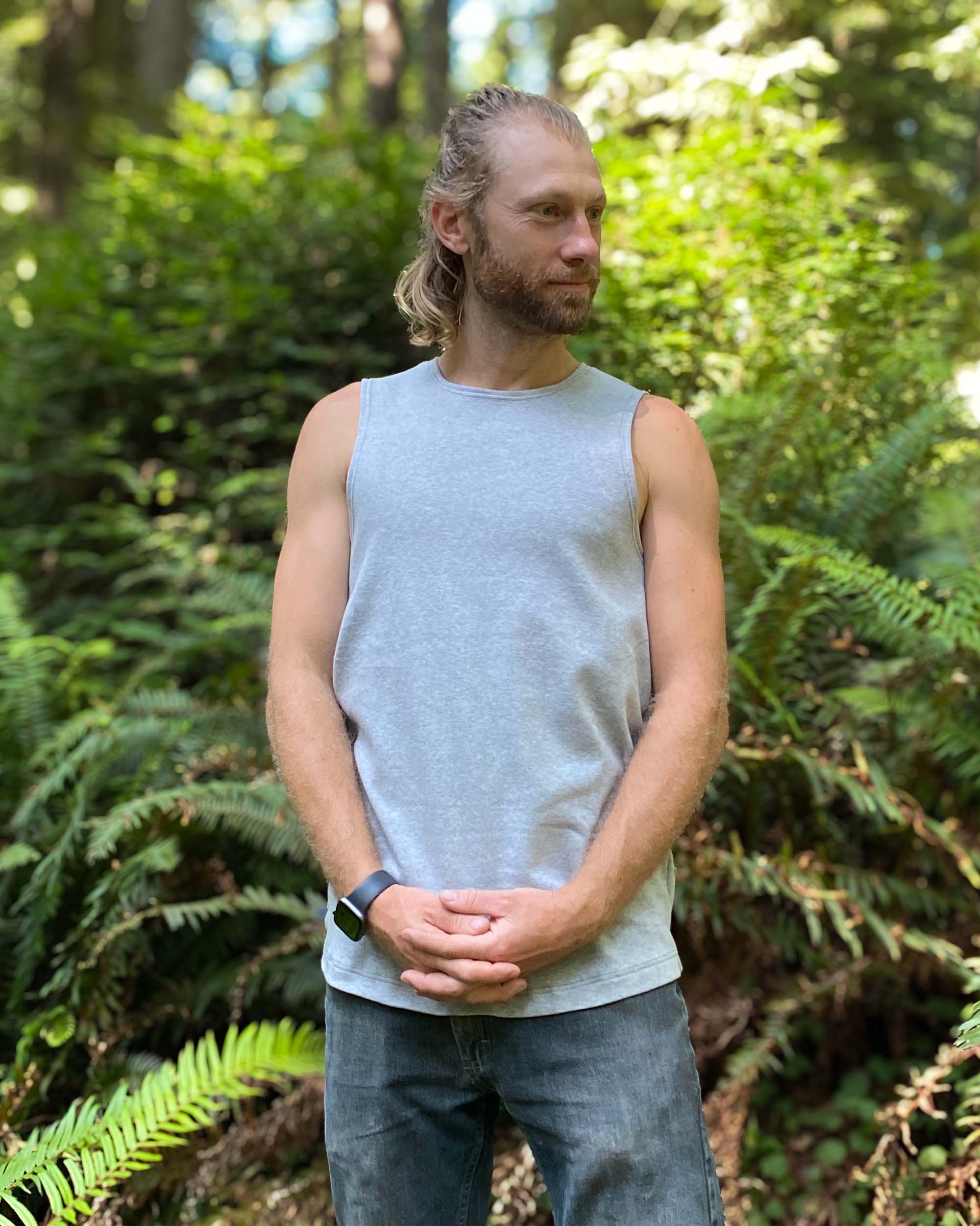Organic cotton mens tank top, grey fabric, front view, on model in nature.