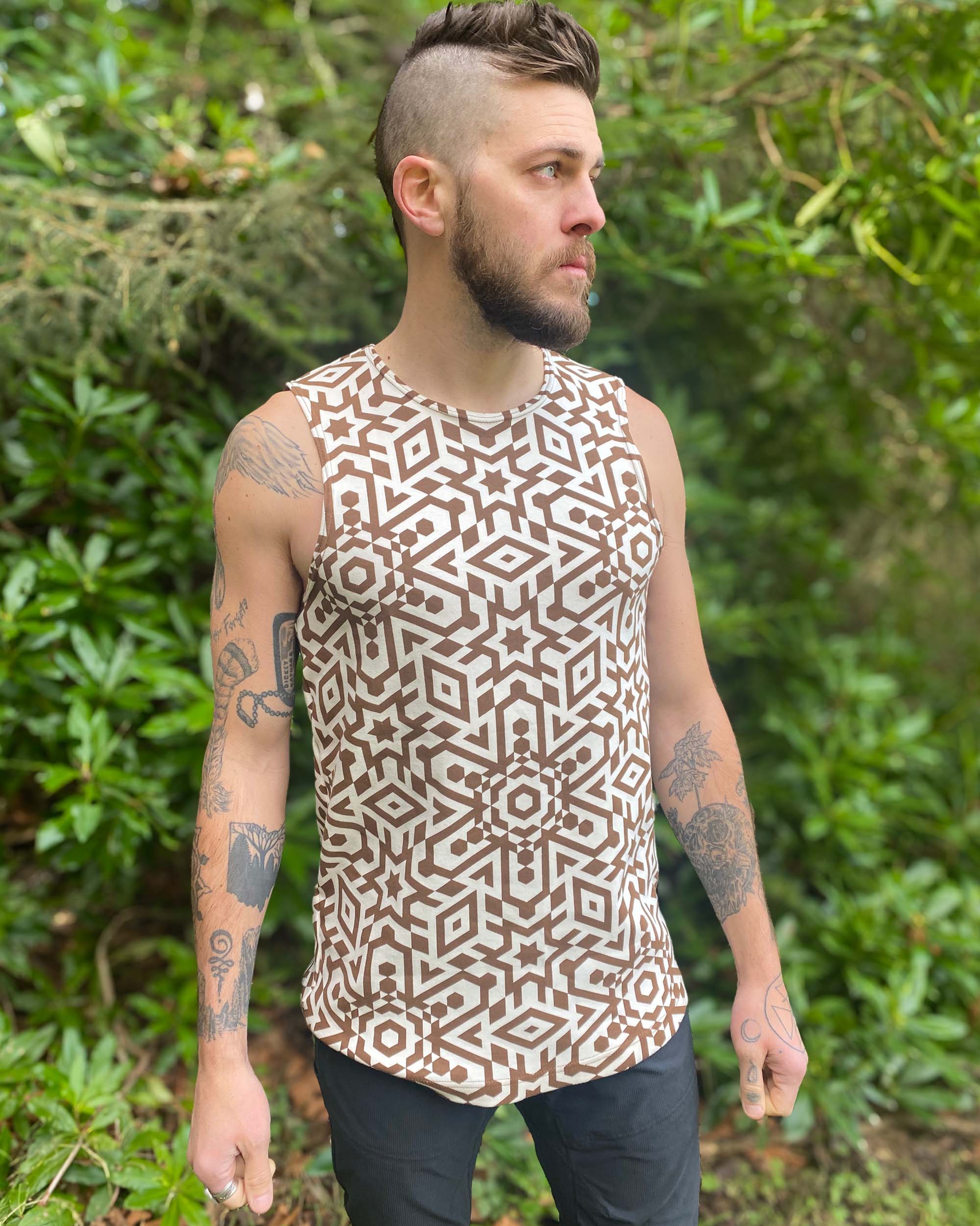 Organic cotton mens tank top, un-dyed fabric with brown geometric print, left side view.