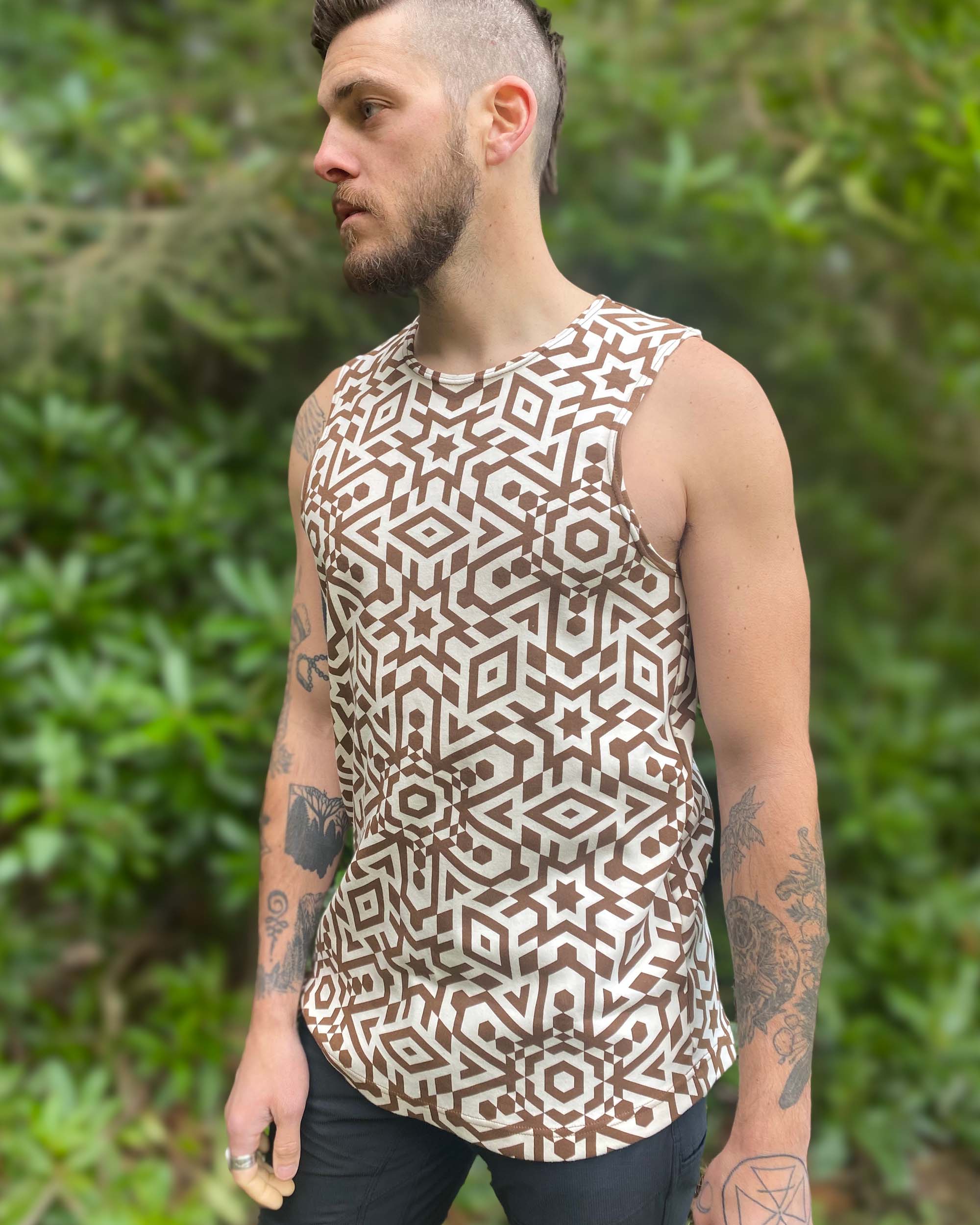 Organic cotton mens tank top, un-dyed fabric with brown geometric print, natural lighting front view.