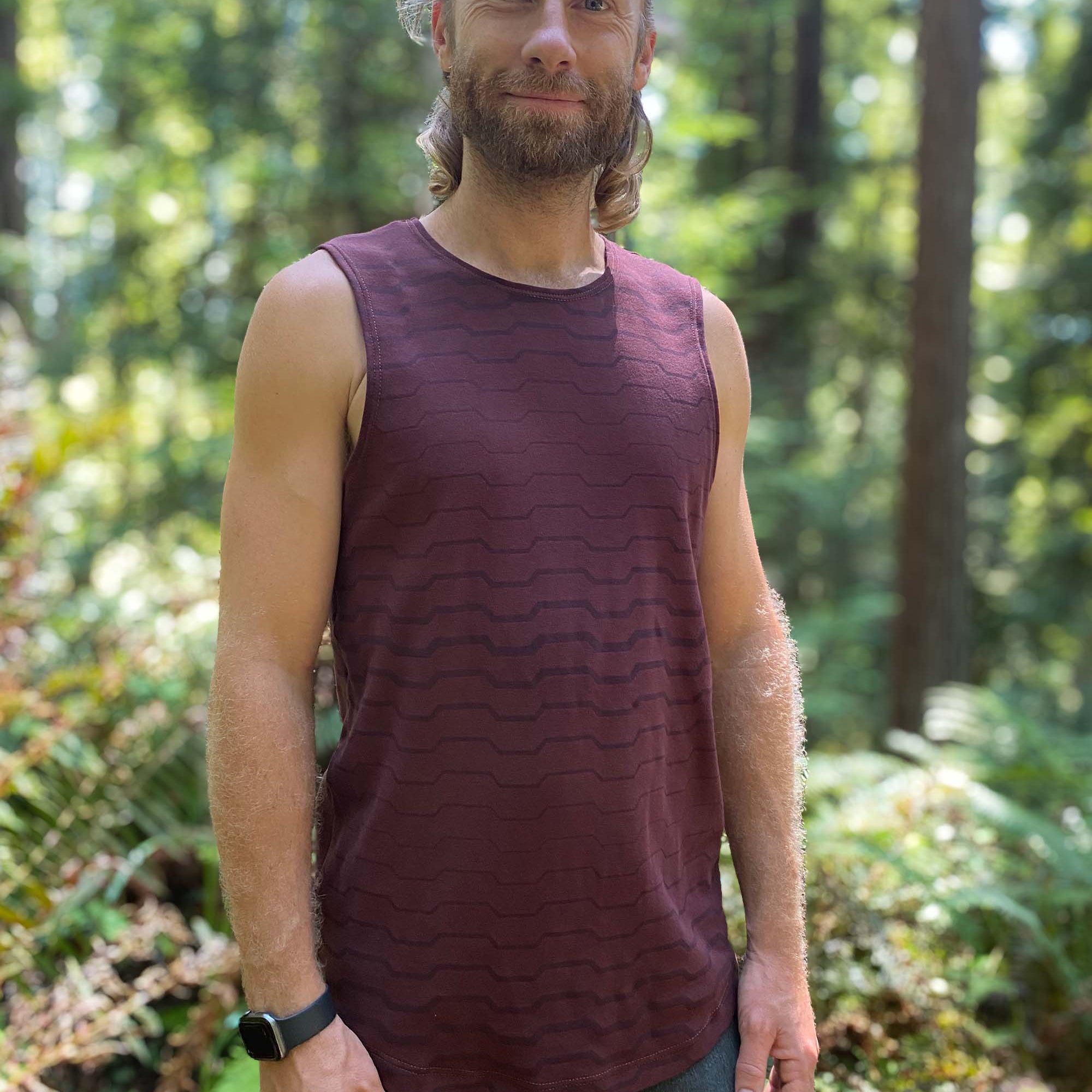 Organic cotton mens tank top, brown fabric with geo print, left side view.
