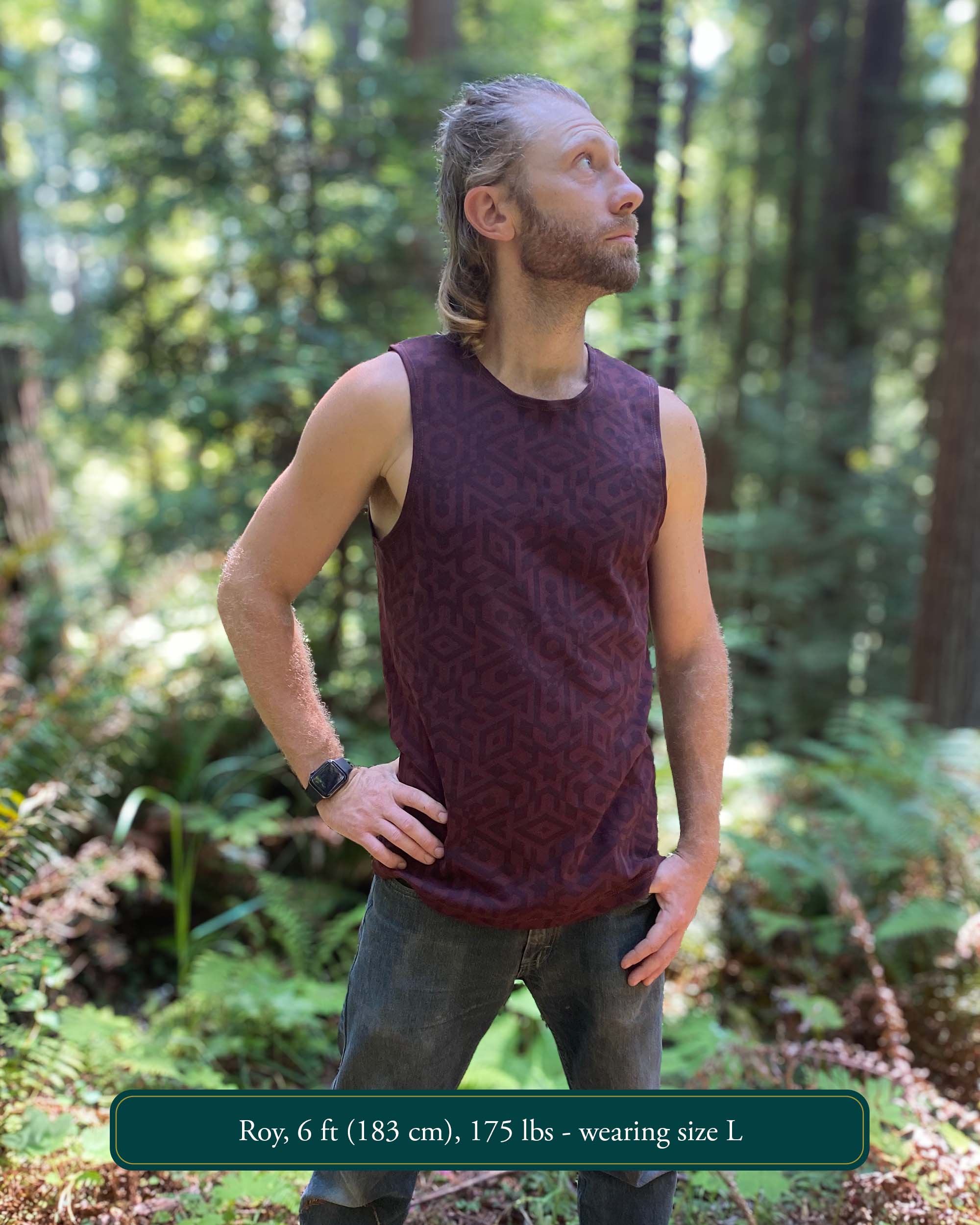 Organic cotton mens tank top, brown fabric with geometric print, left side view with model in natural light.