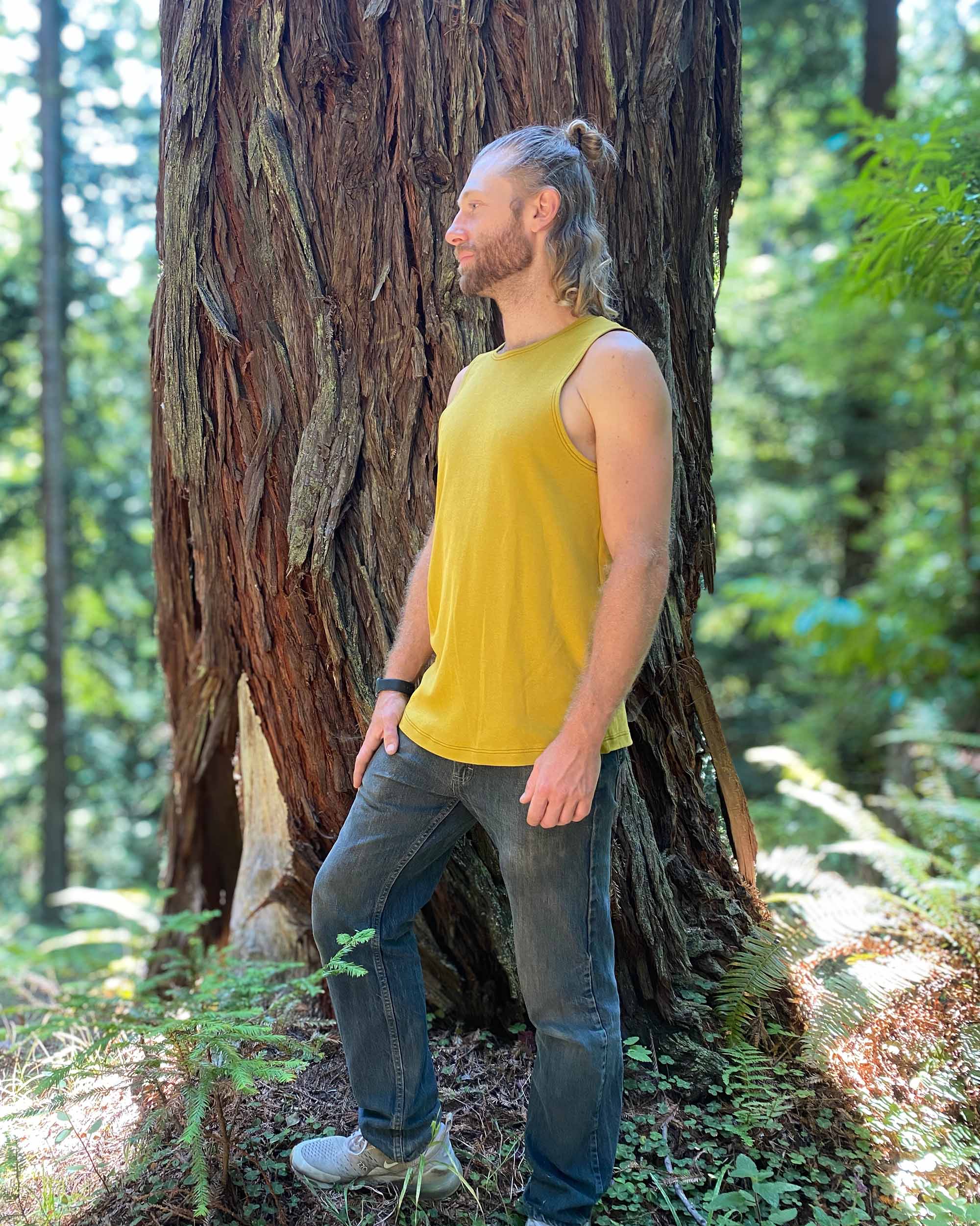 Organic cotton mens tank top, yellow fabric, right side view on model.