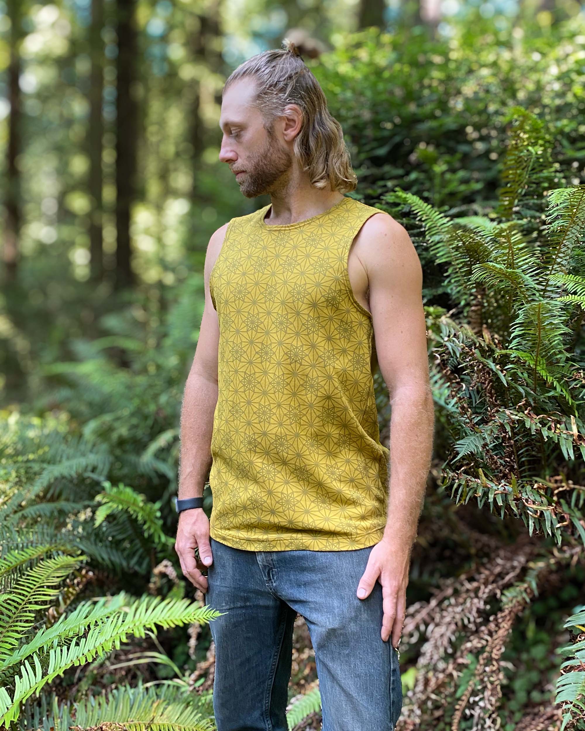 Organic cotton mens tank top, yellow fabric with geometric print, side view.