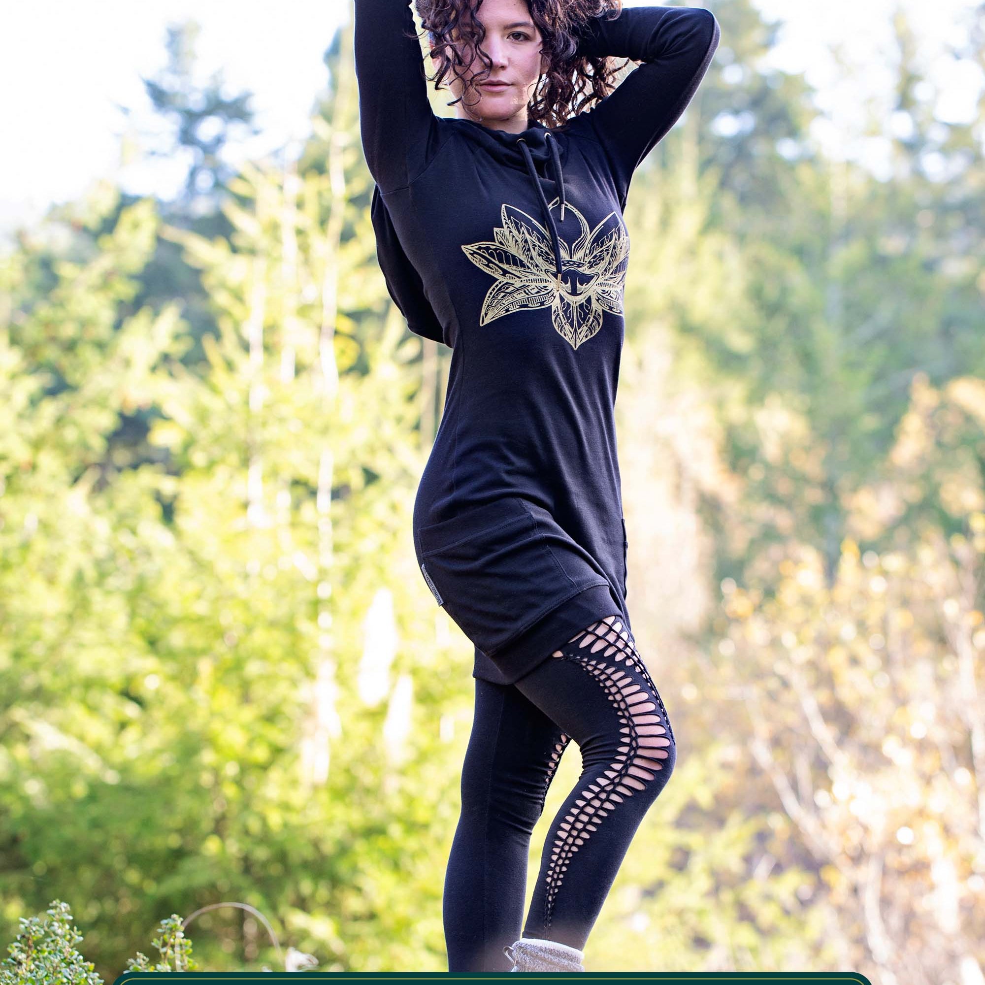 Organic cotton long sleeve tunic dress, black with front gold lotus print, full length front view on female model.