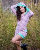 Organic cotton fitted tunic dress, pink fabric with geometric print, front view worn by female model.