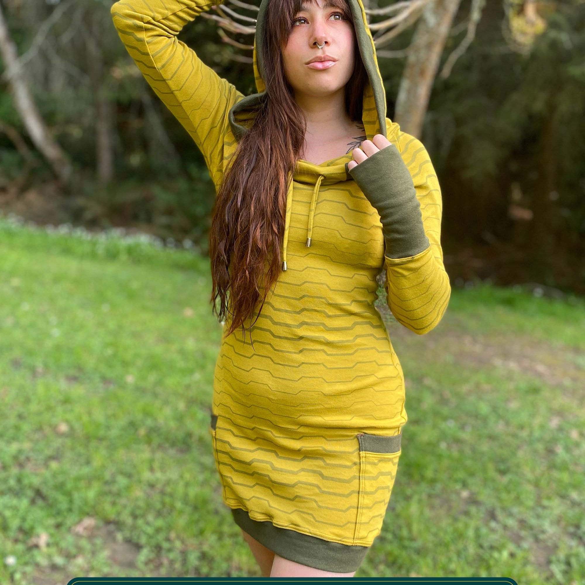 Organic cotton long sleeve tunic dress, yellow with green accent fabric, front view on female model.