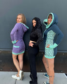 3 models wearing fitted tunic dresses in different color fabrics with matching geometric prints.