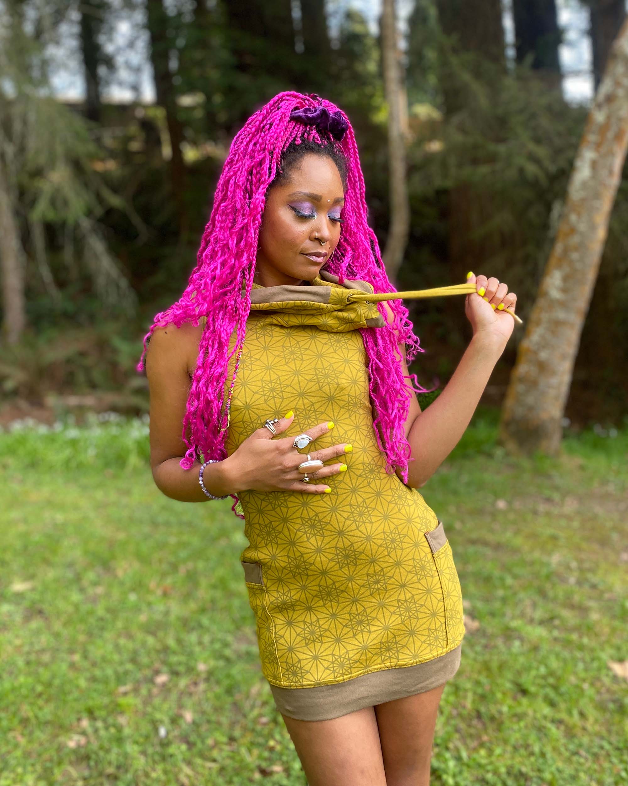 Organic cotton sleeveless tunic dress, yellow fabric with geometric print, front view on female model.