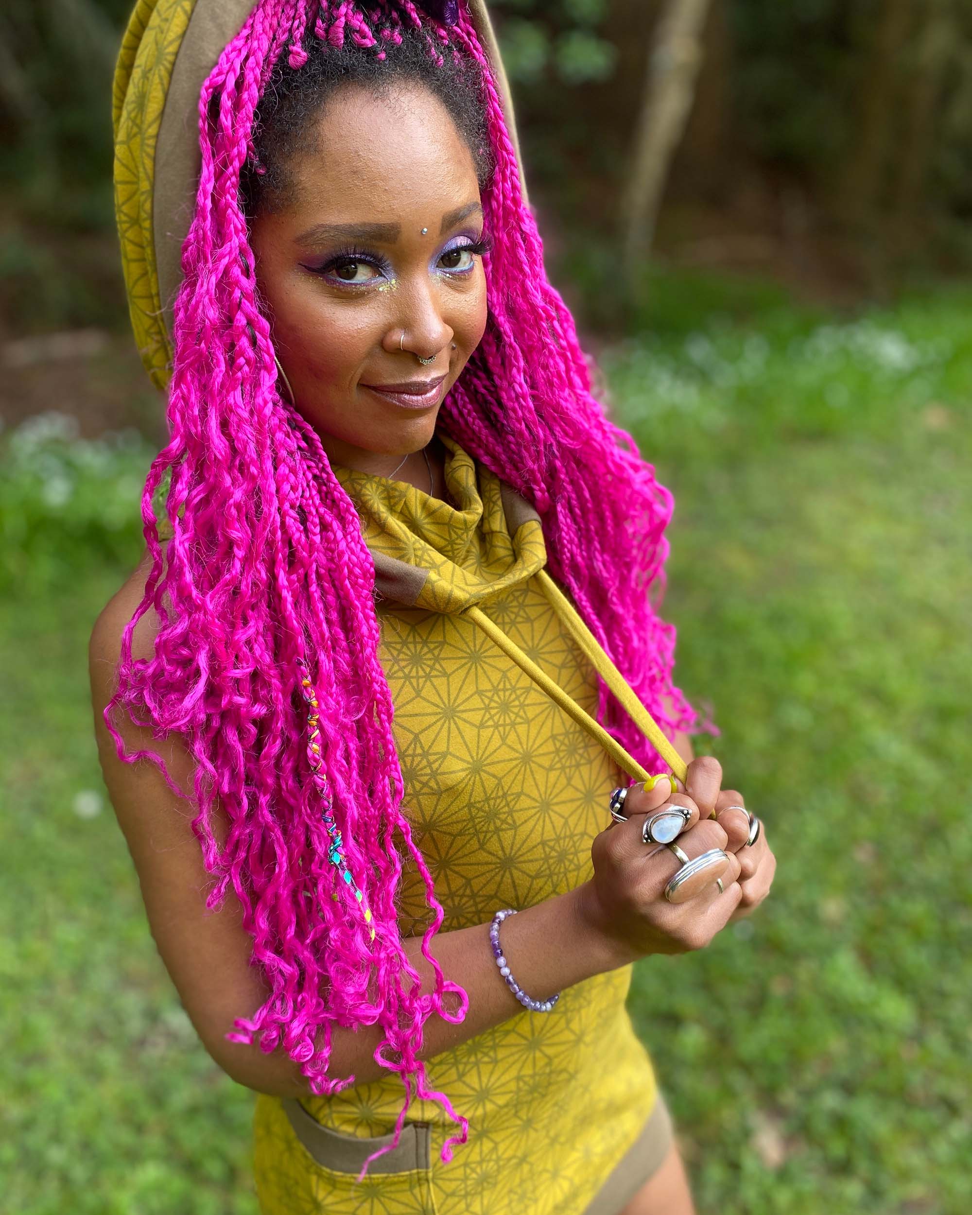 Organic cotton sleeveless tunic dress, yellow fabric with geometric print, detail view of hood drawcords.