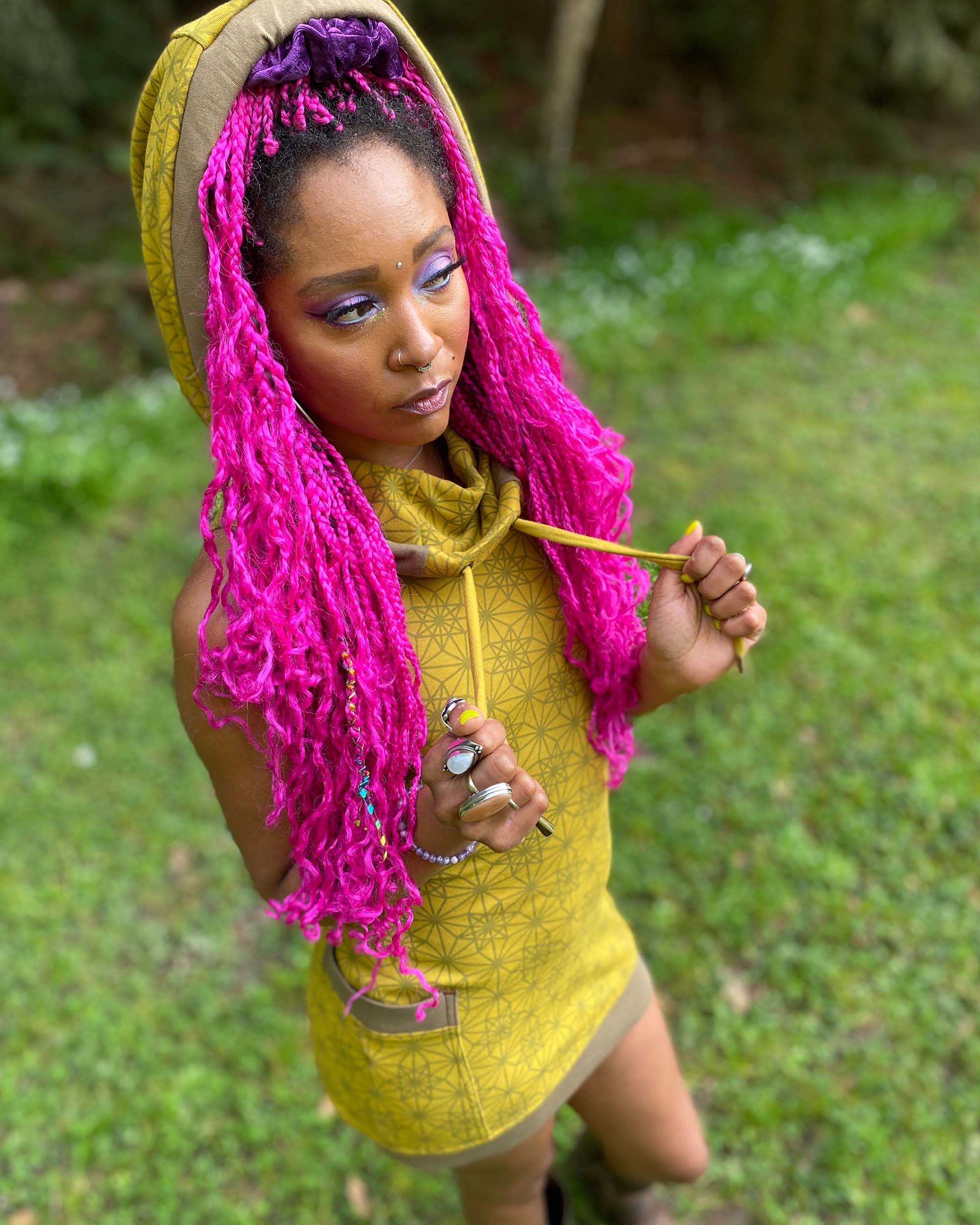 Organic cotton sleeveless tunic dress, yellow fabric with geometric print, top front view on female model.