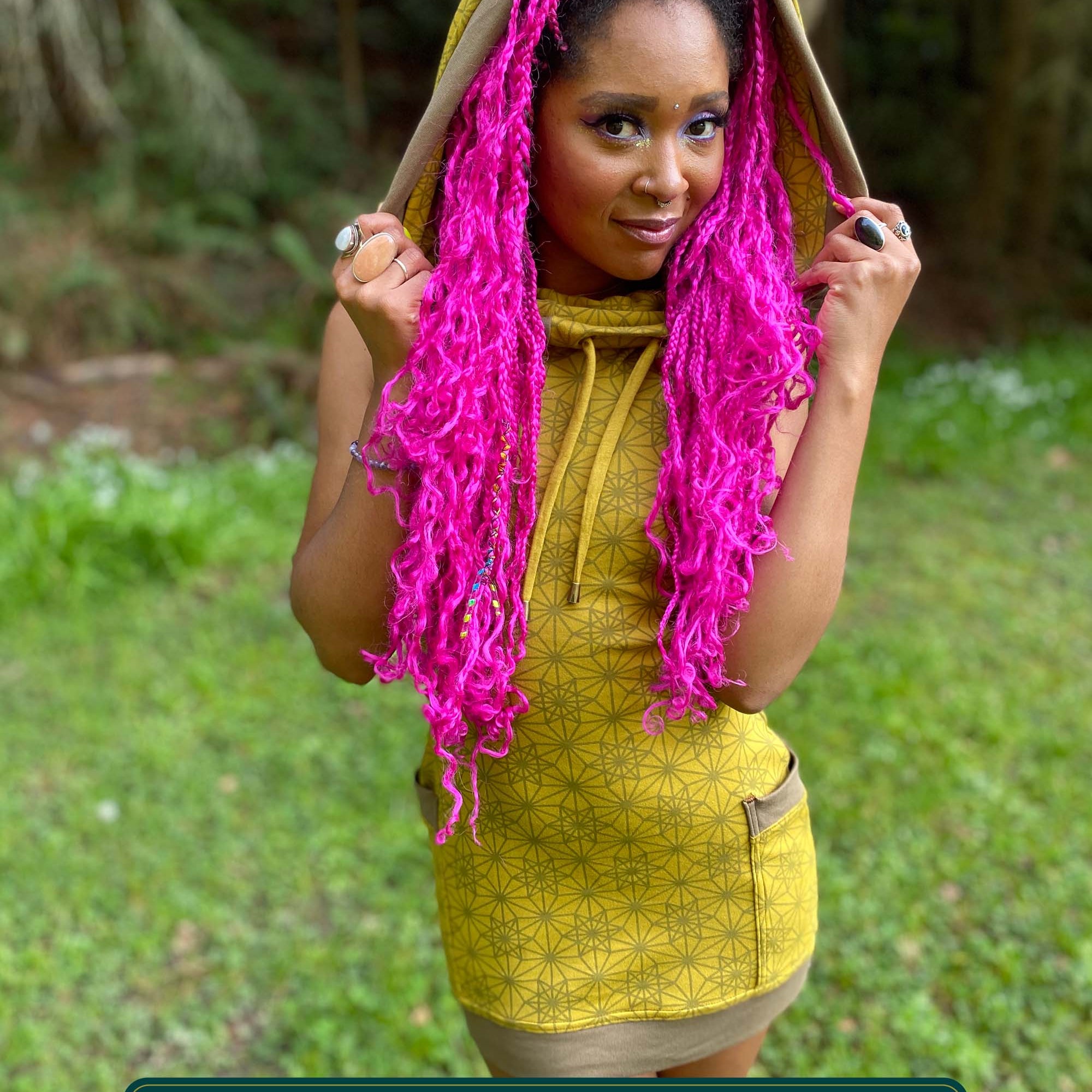 Organic cotton sleeveless tunic dress, yellow fabric with sacred geometry print, front view on female model.