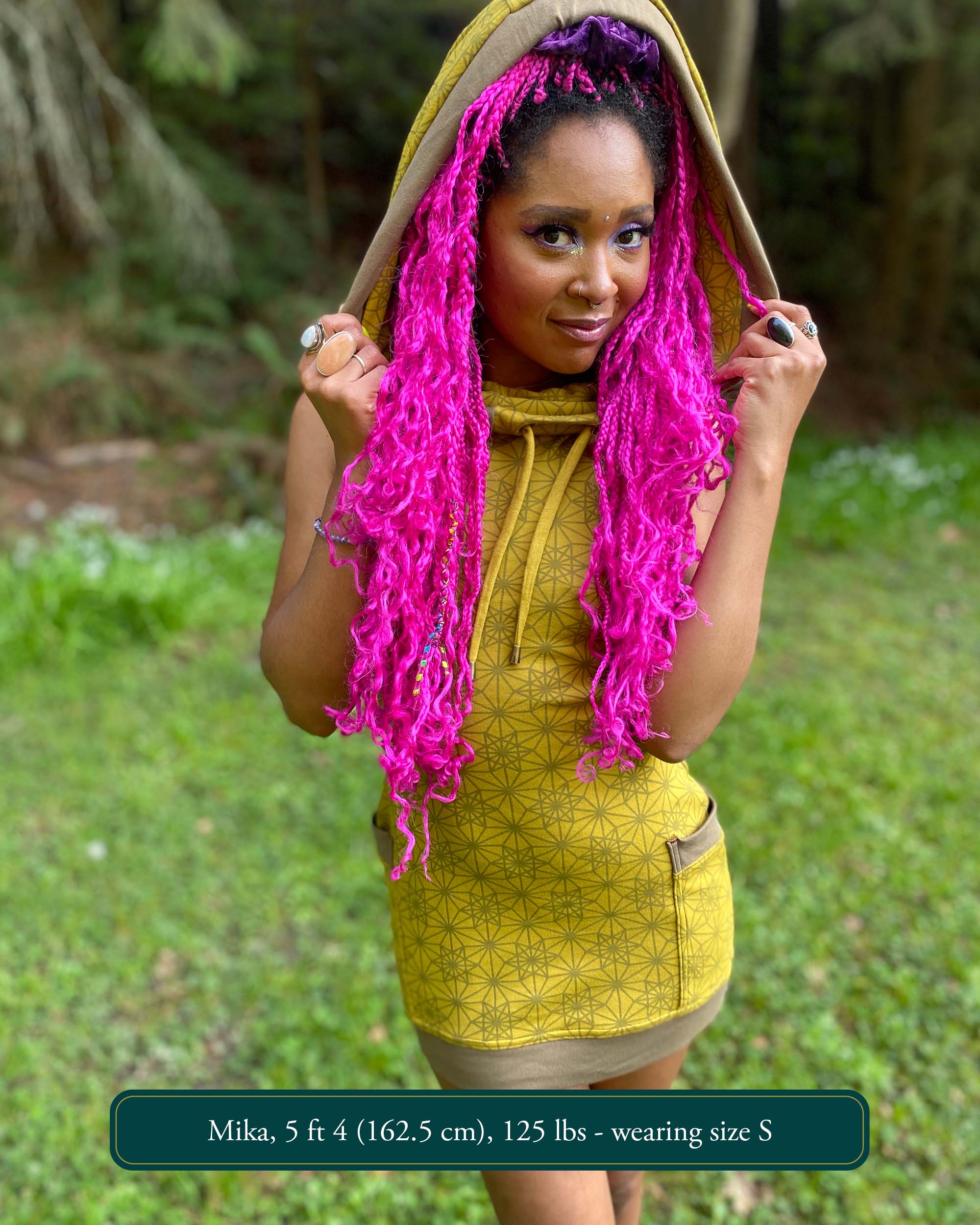 Organic cotton sleeveless tunic dress, yellow fabric with sacred geometry print, front view on female model.