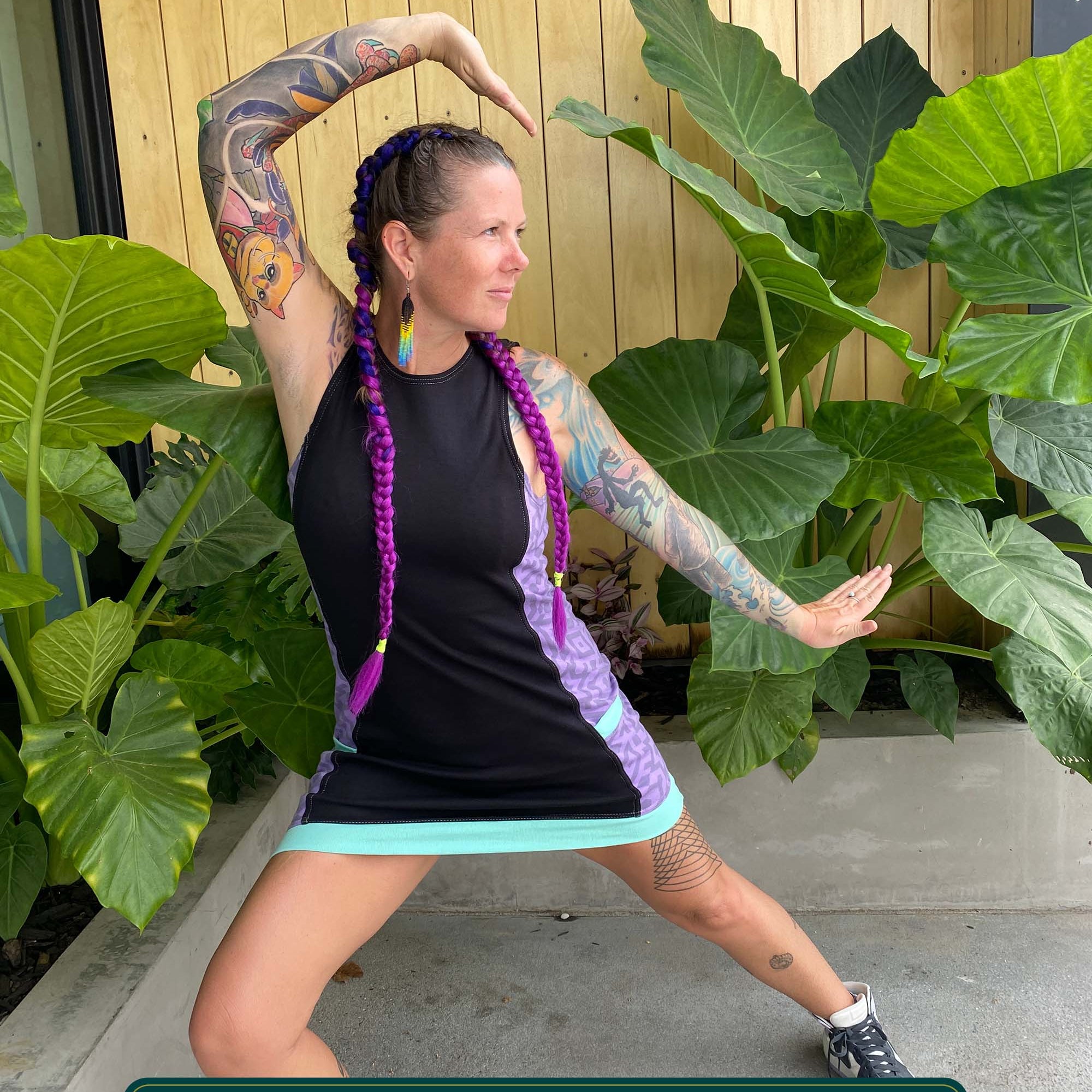 Organic cotton sleeveless dress, black fabric with lavender accent fabric and geometric print.