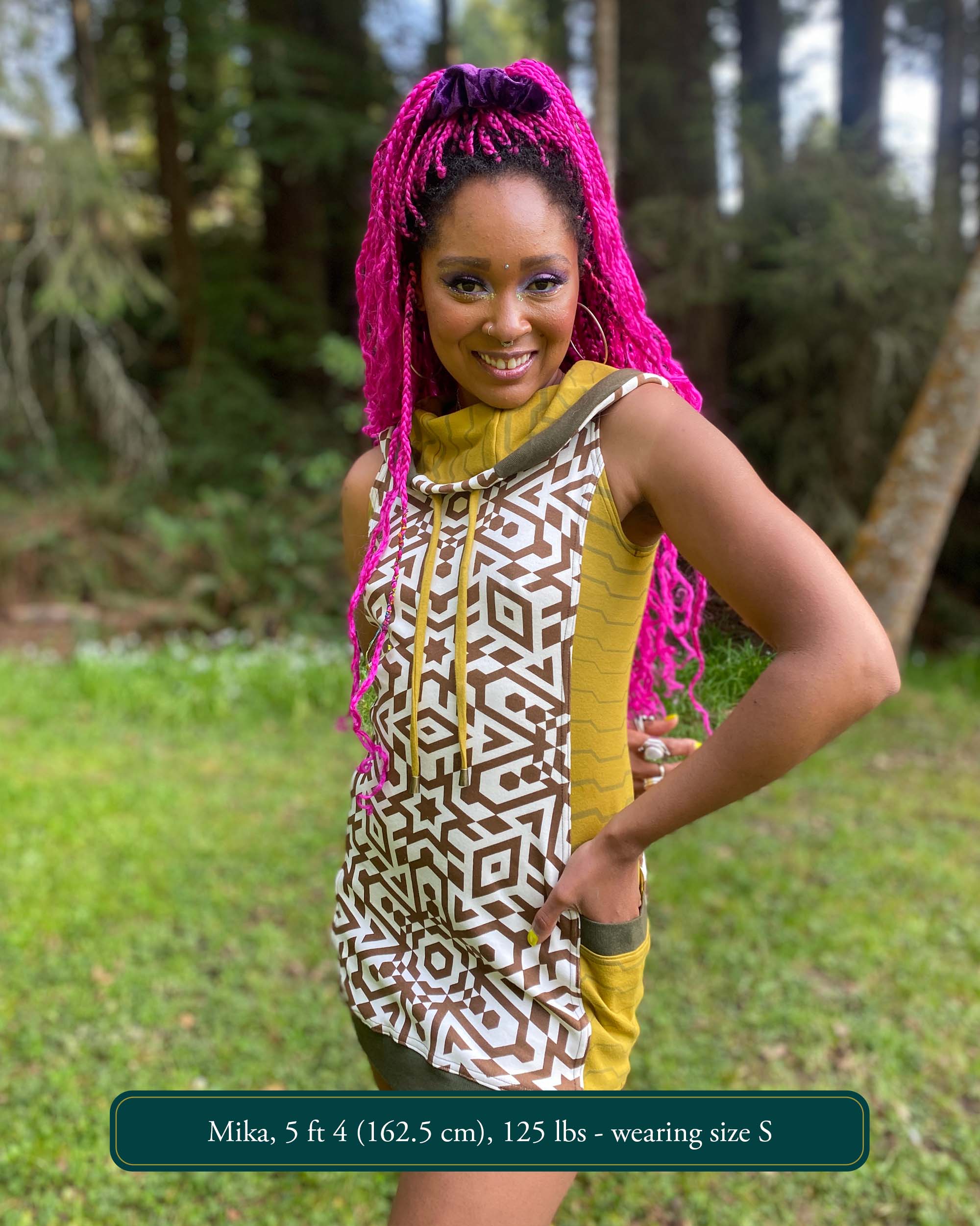 Cotton sleeveless hooded dress, natural fabric color with brown geometric print, front view of female model.