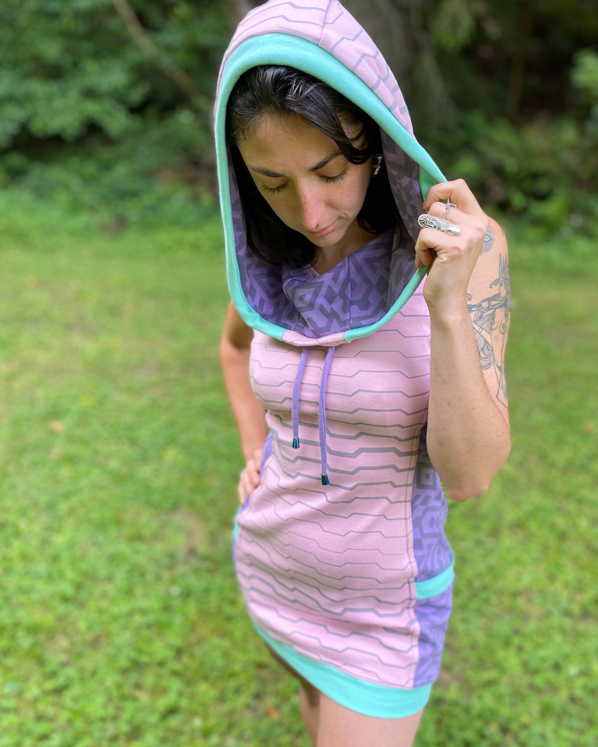 Organic cotton sleeveless tunic dress, pink and lavender colored fabric, detail of hood.