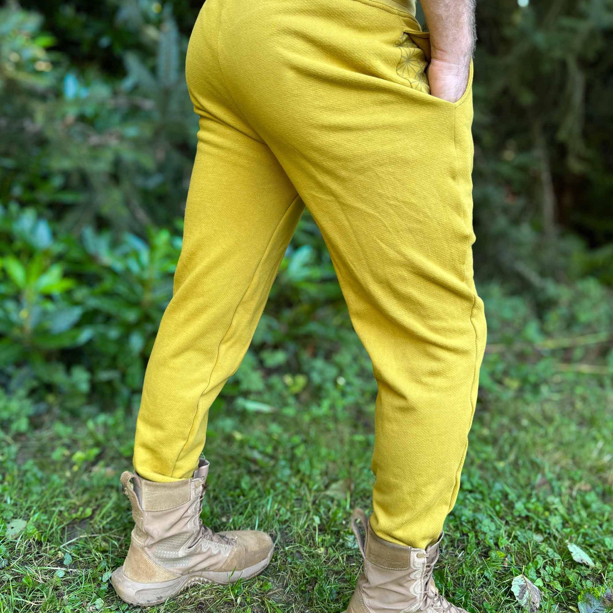 Organic cotton fleece joggers, solid yellow fabric, back side view on male model.