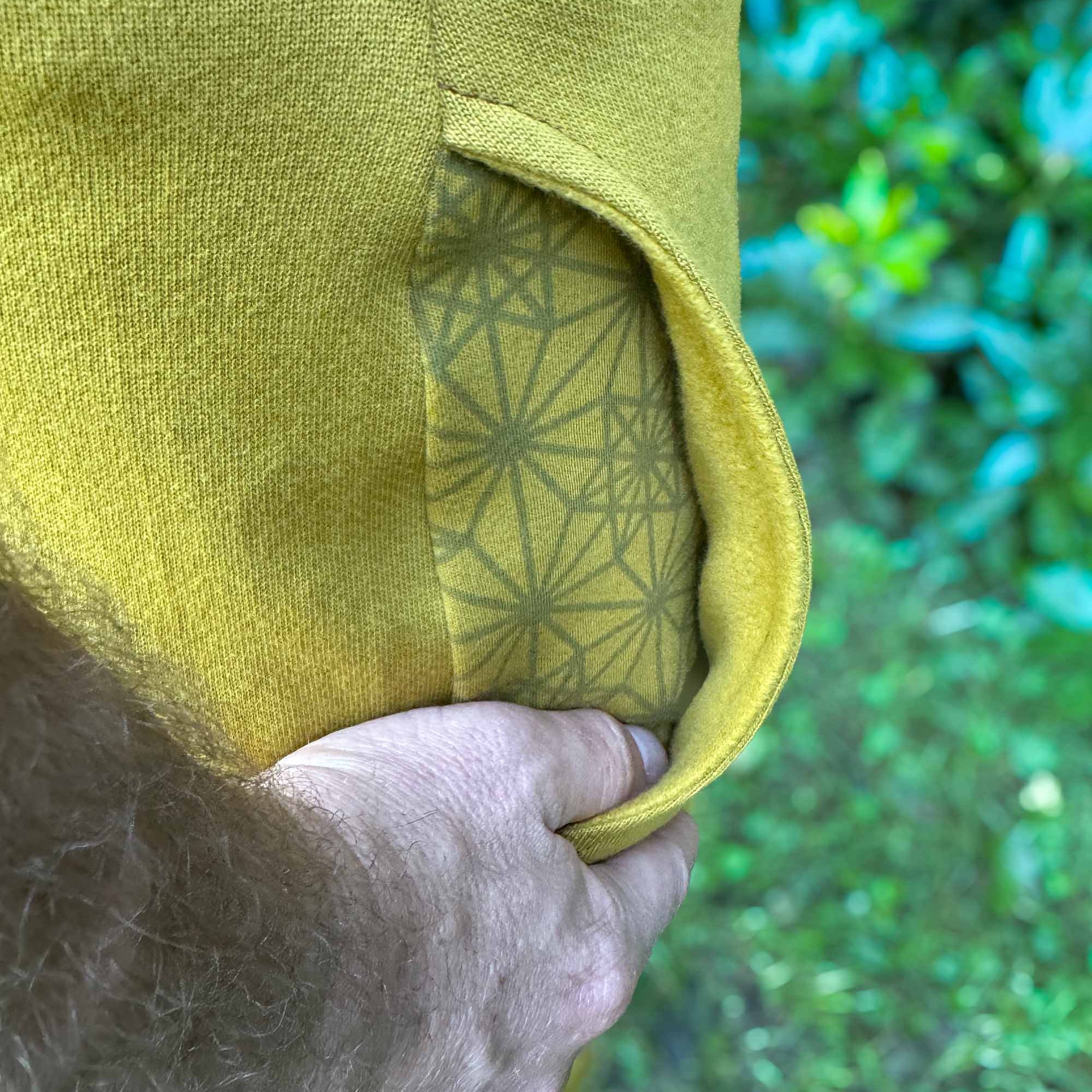 Organic cotton fleece joggers, solid yellow fabric, detail of inside fleece lined pocket.