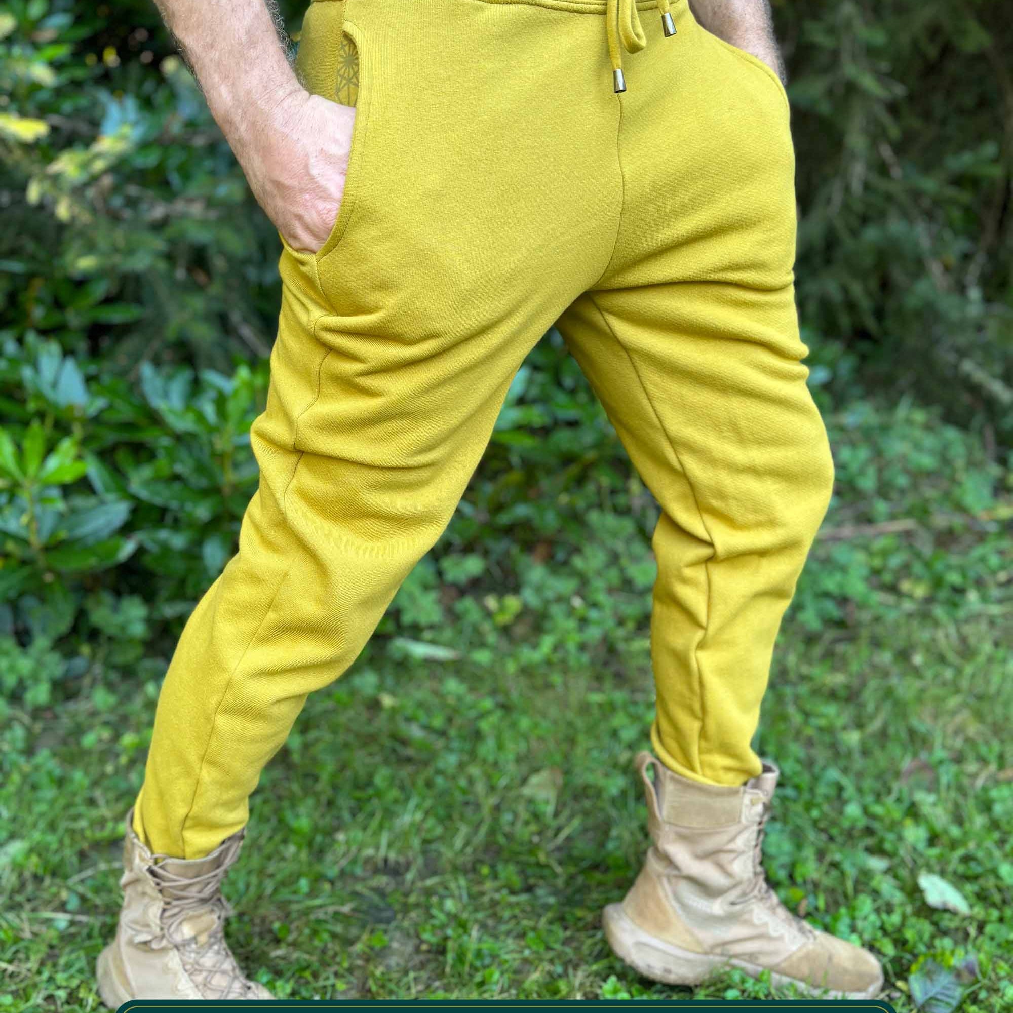 Organic cotton fleece joggers, solid yellow fabric, right side view on male model.