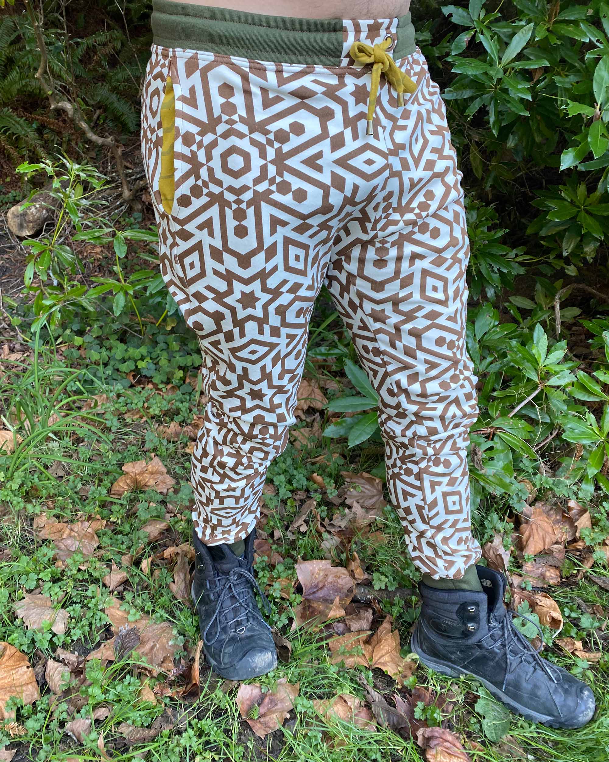 Organic cotton unisex joggers, undyed fabric with brown geometric print, right side view on male model.