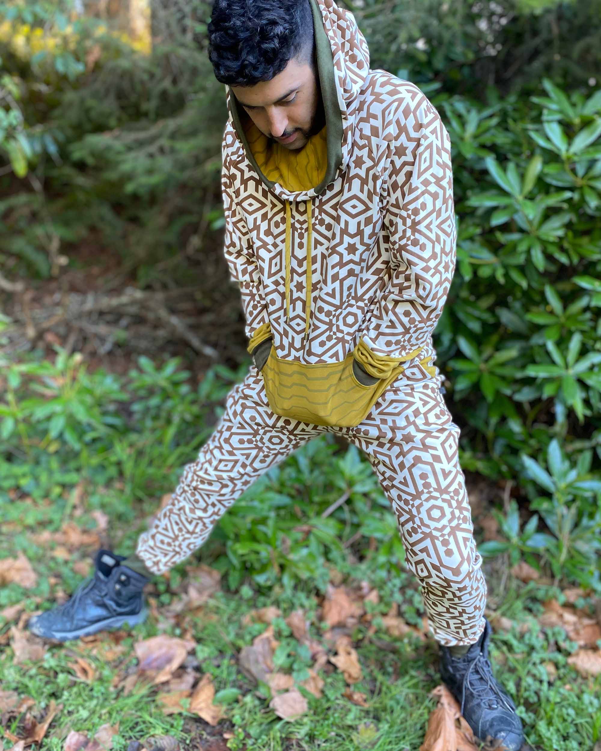 Full body view of model in organic cotton unisex joggers and matching undyed hoodie with brown geometric print.