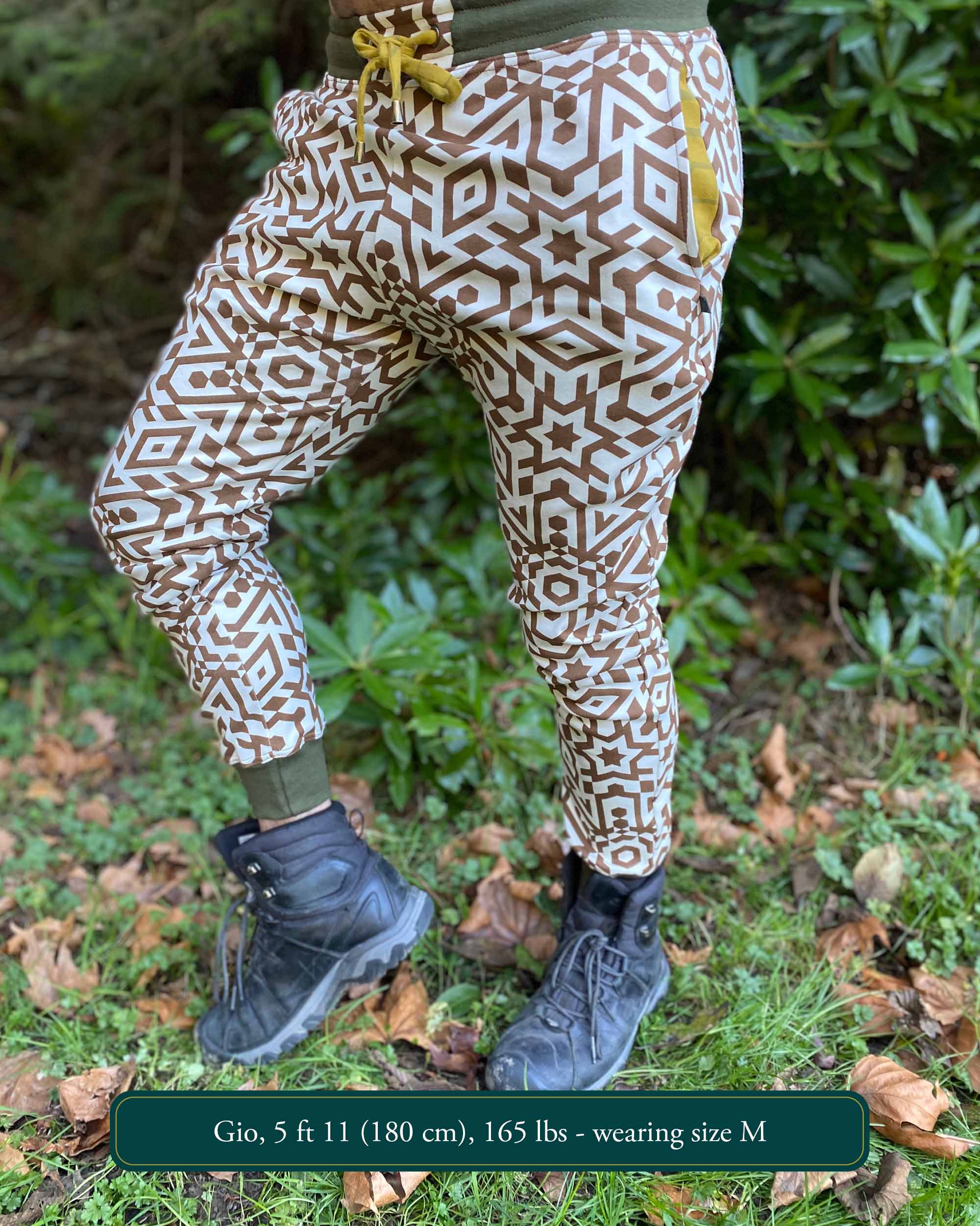 Organic cotton unisex joggers, undyed fabric with brown geometric print, left side view on male model.