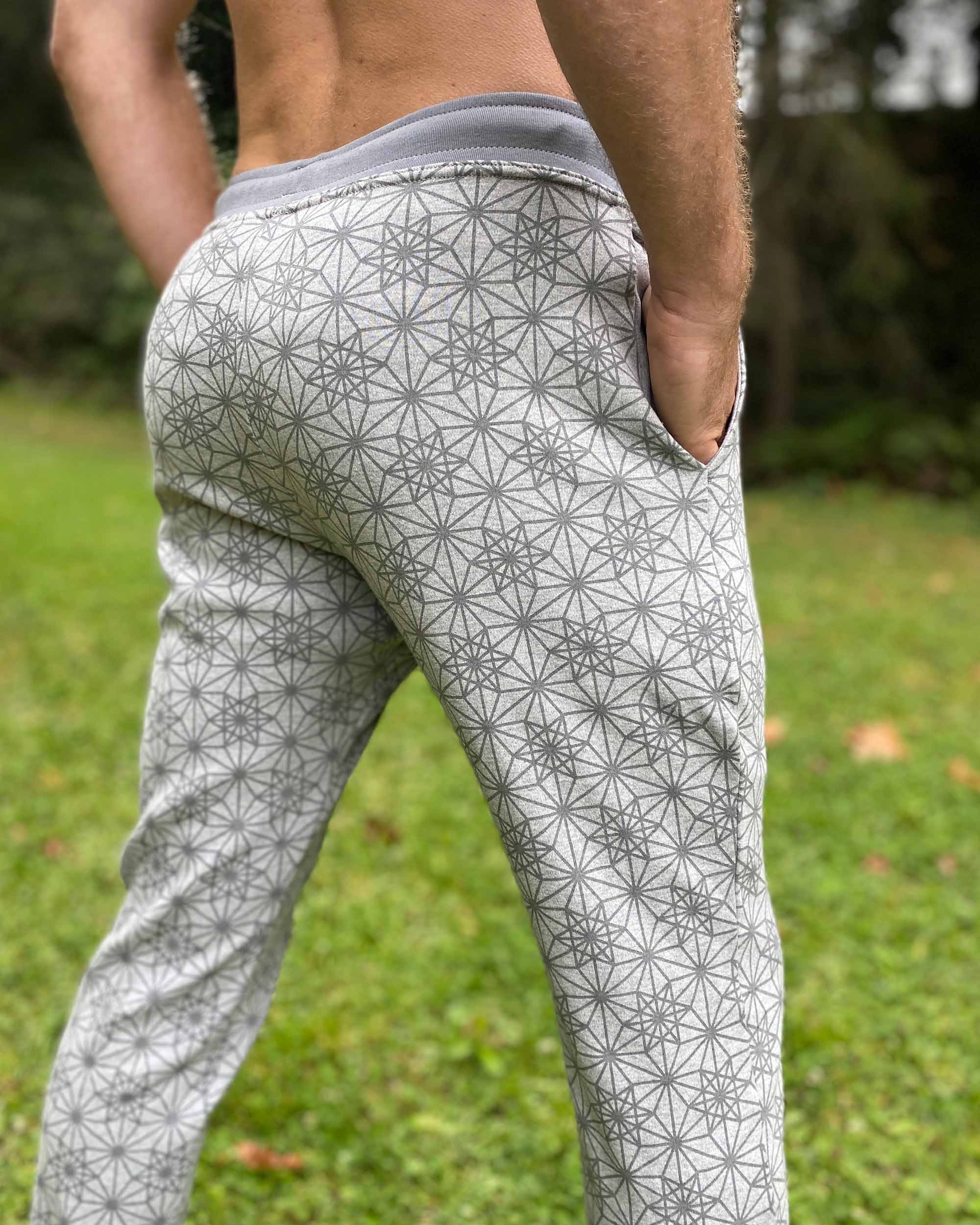 Organic cotton unisex joggers, grey fabric with geometric print, detail back view on male model.