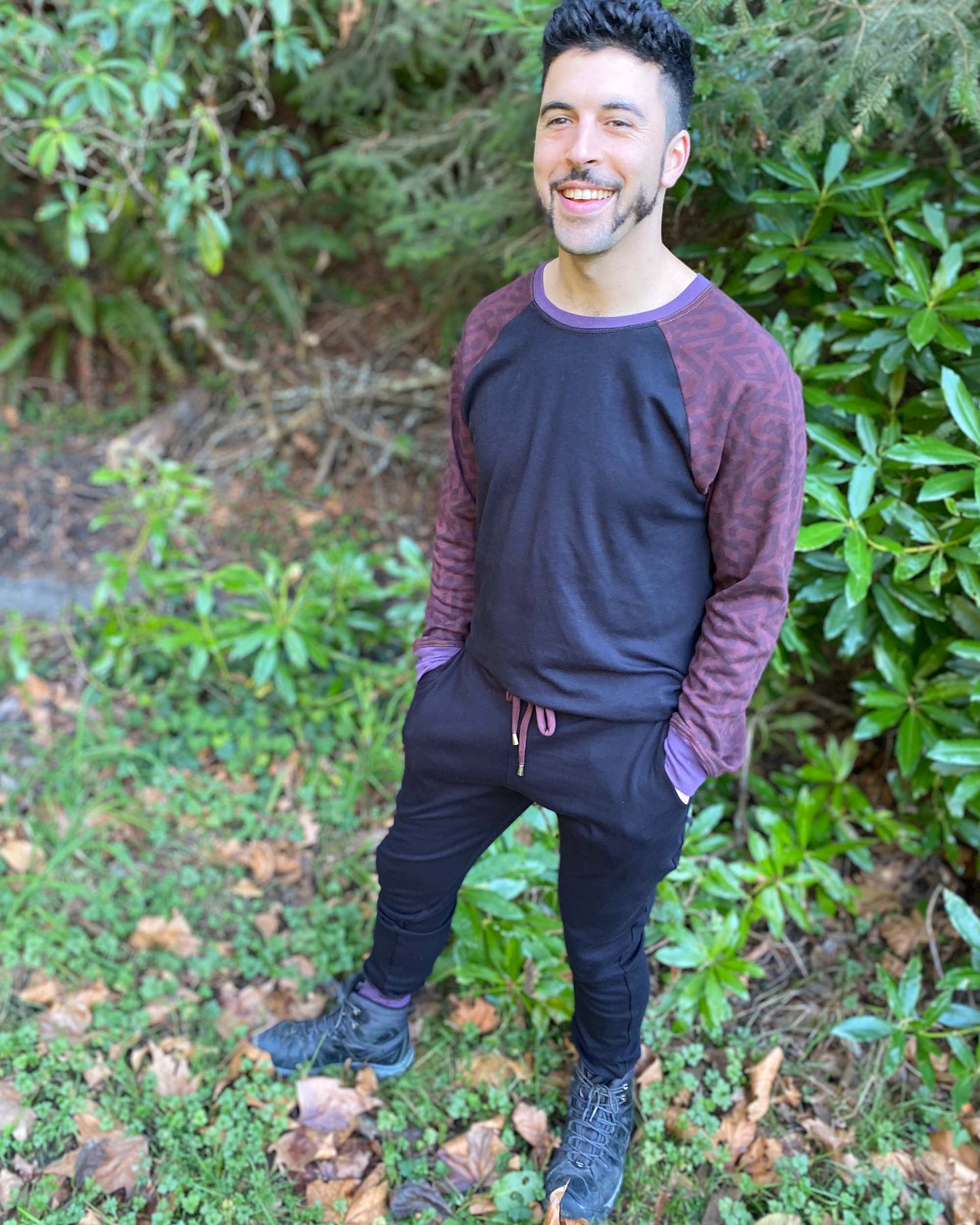 Male model wearing black fabric and brown accented matching long sleeve shirt and joggers.
