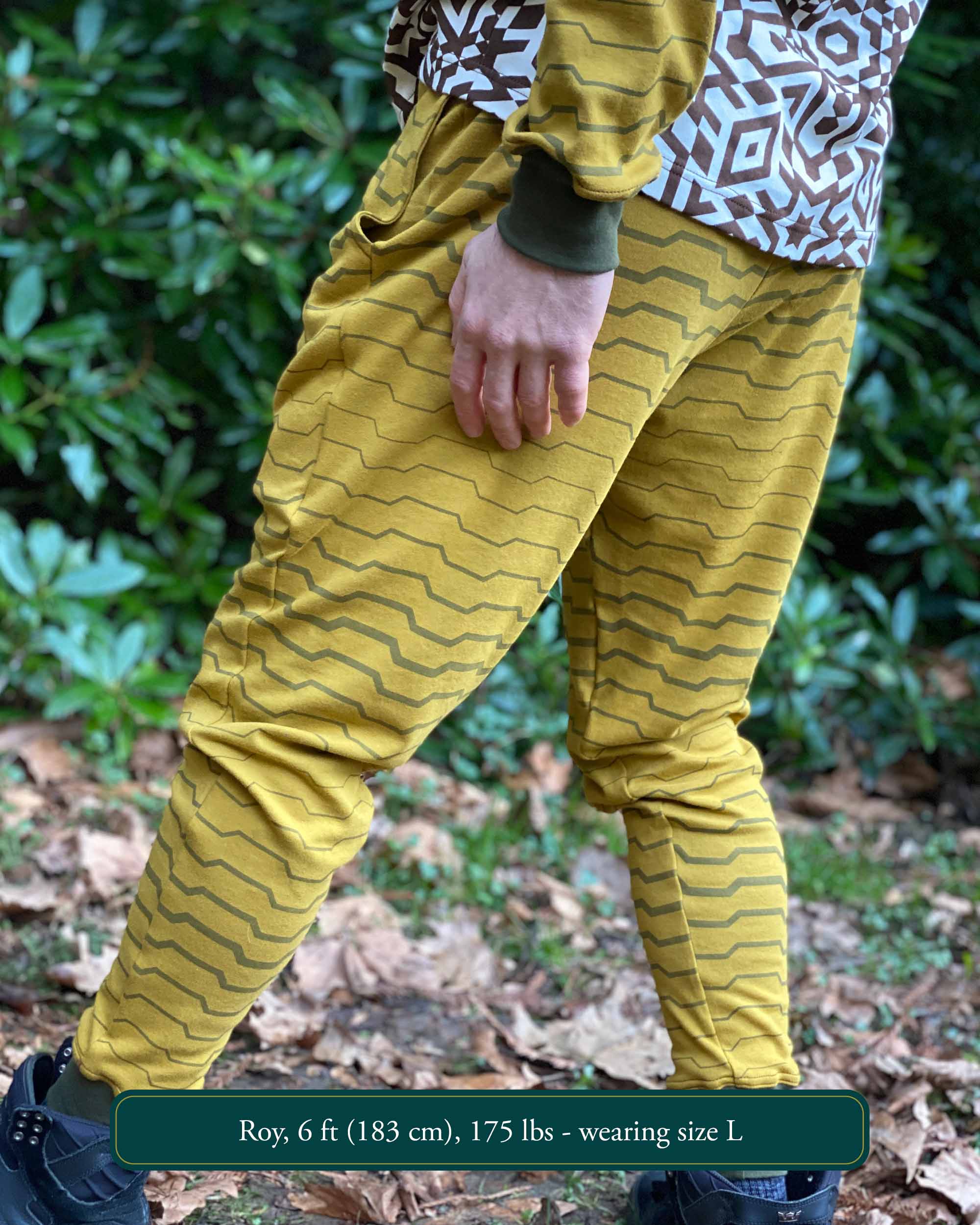 Organic cotton unisex joggers, yellow fabric with brown geometric print, back left side view on male model.