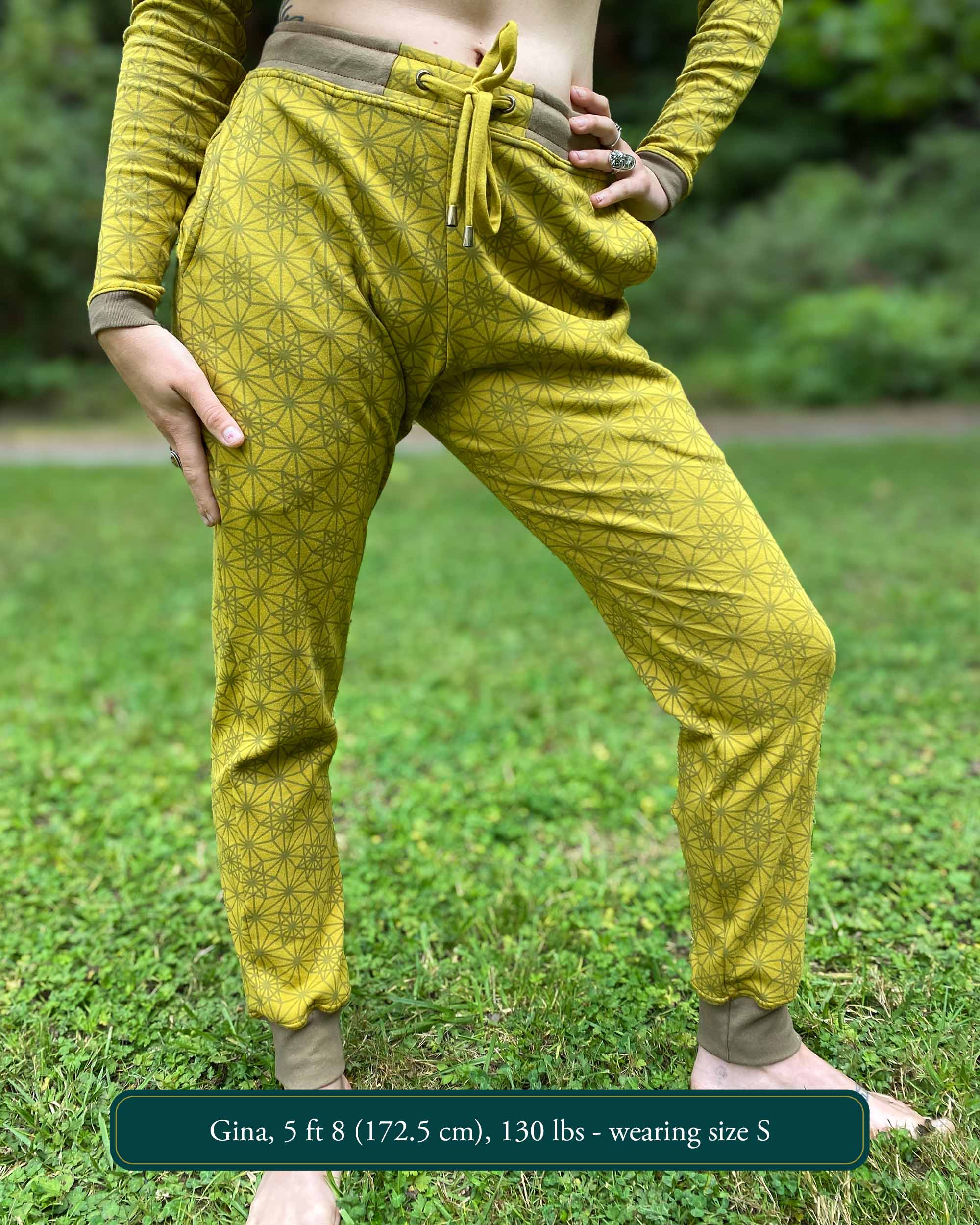 Organic cotton unisex joggers, yellow fabric with geometric print, front view on female model.