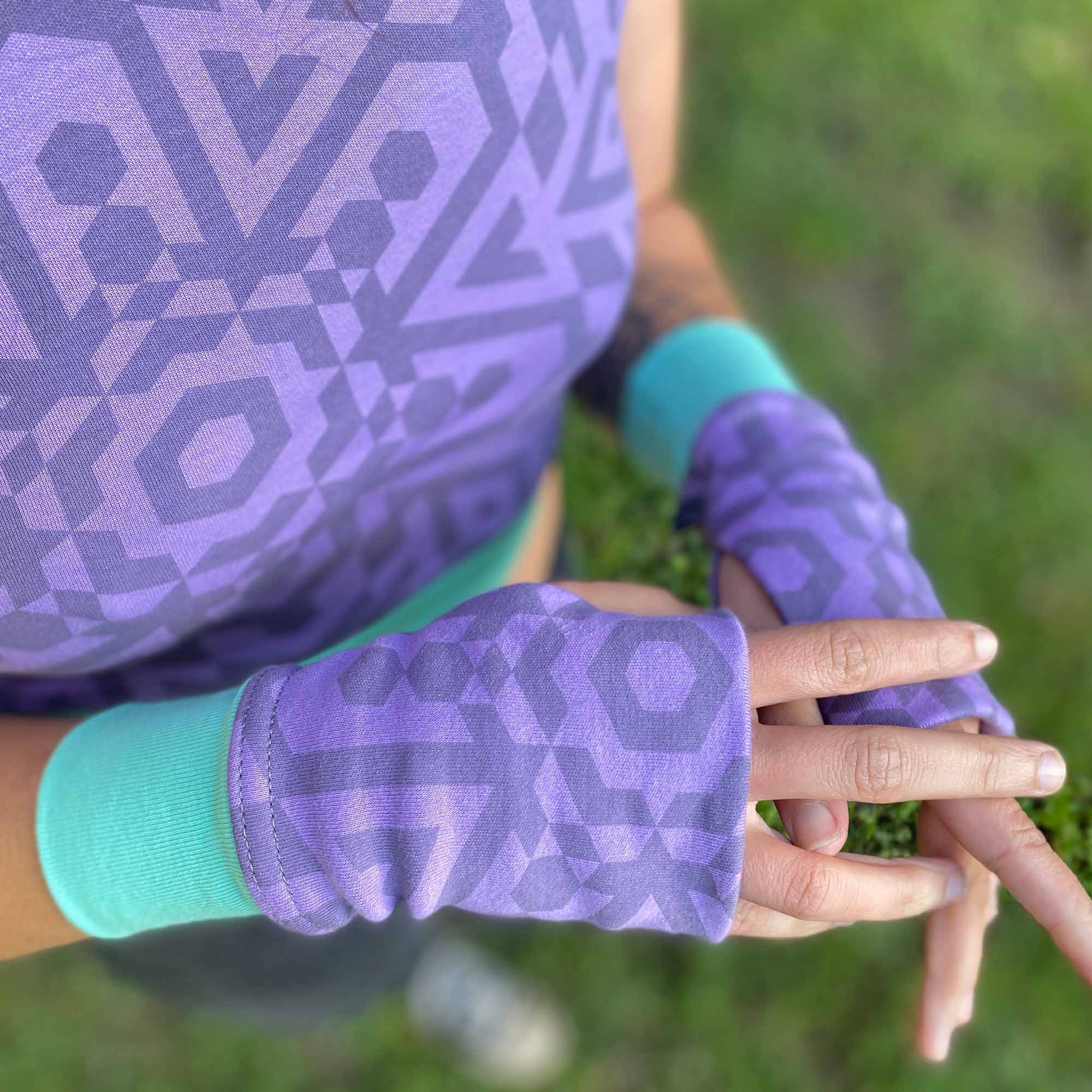 Organic cotton fingerless gloves in lavender fabric and geometric print, top detail view.