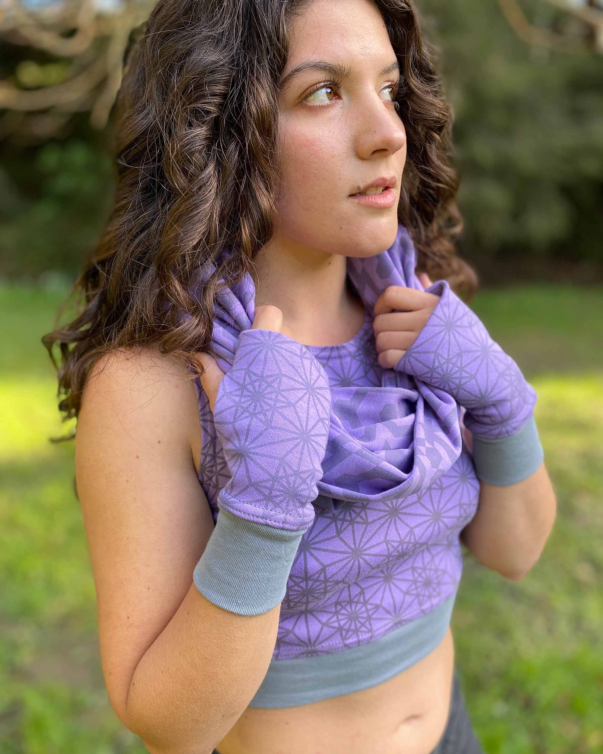 Organic cotton hand warmers, lavender fabric with geometric print, right side view with female model.