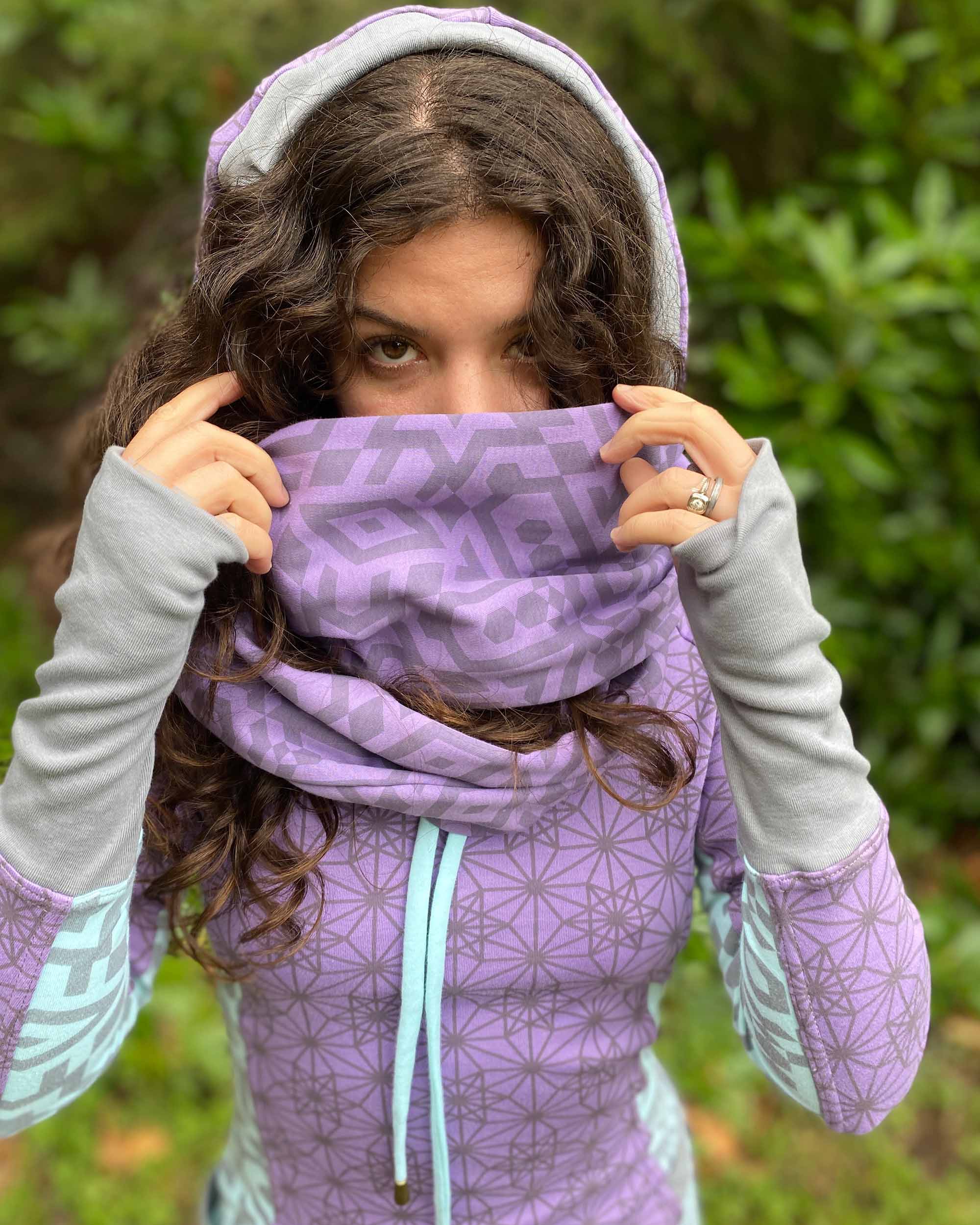 Organic cotton infinity scarf, lavender fabric with geometric print, front view on female model.