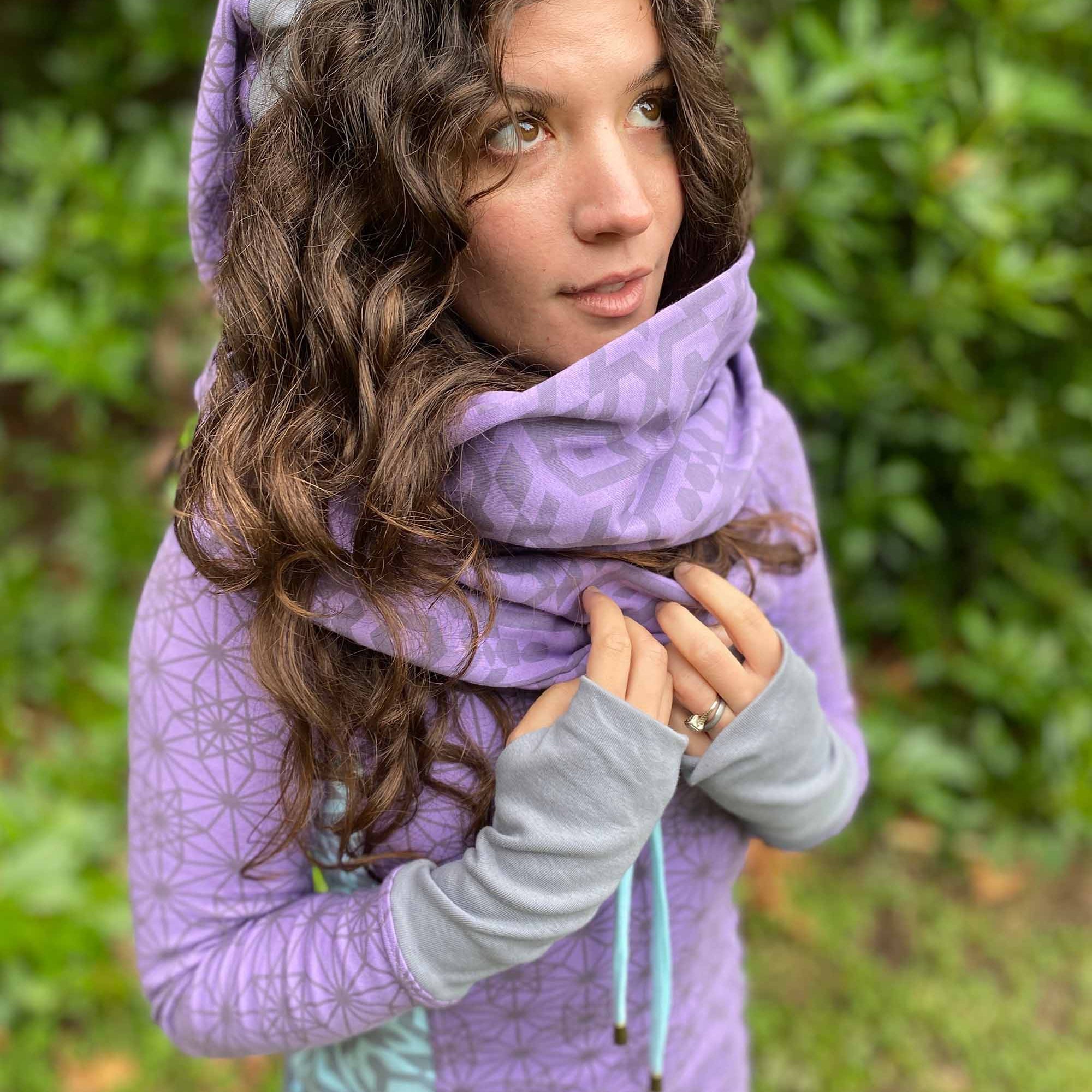 Organic cotton infinity scarf, lavender fabric with geometric print, side view on female model.