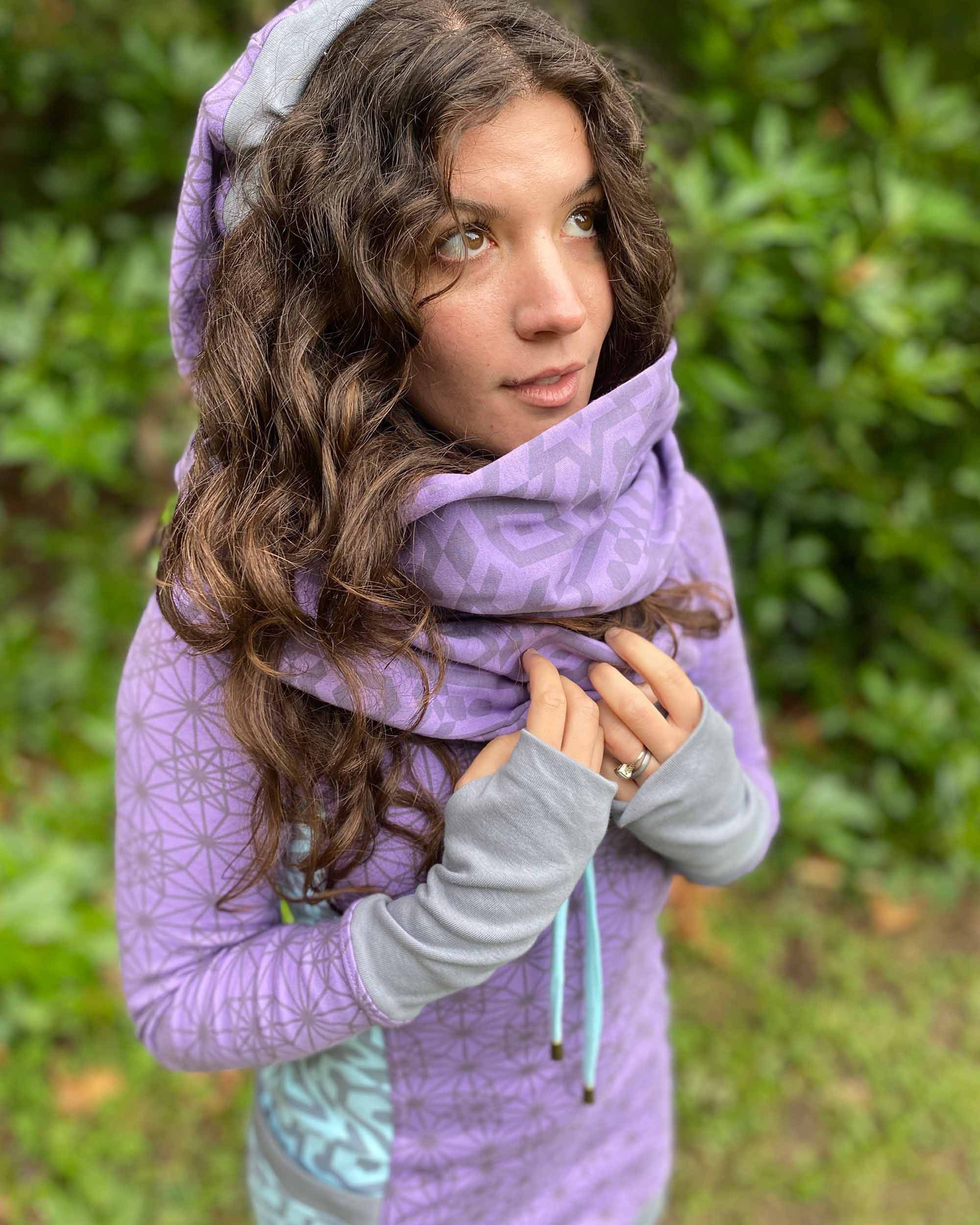 Organic cotton infinity scarf, lavender fabric with geometric print, side view on female model.