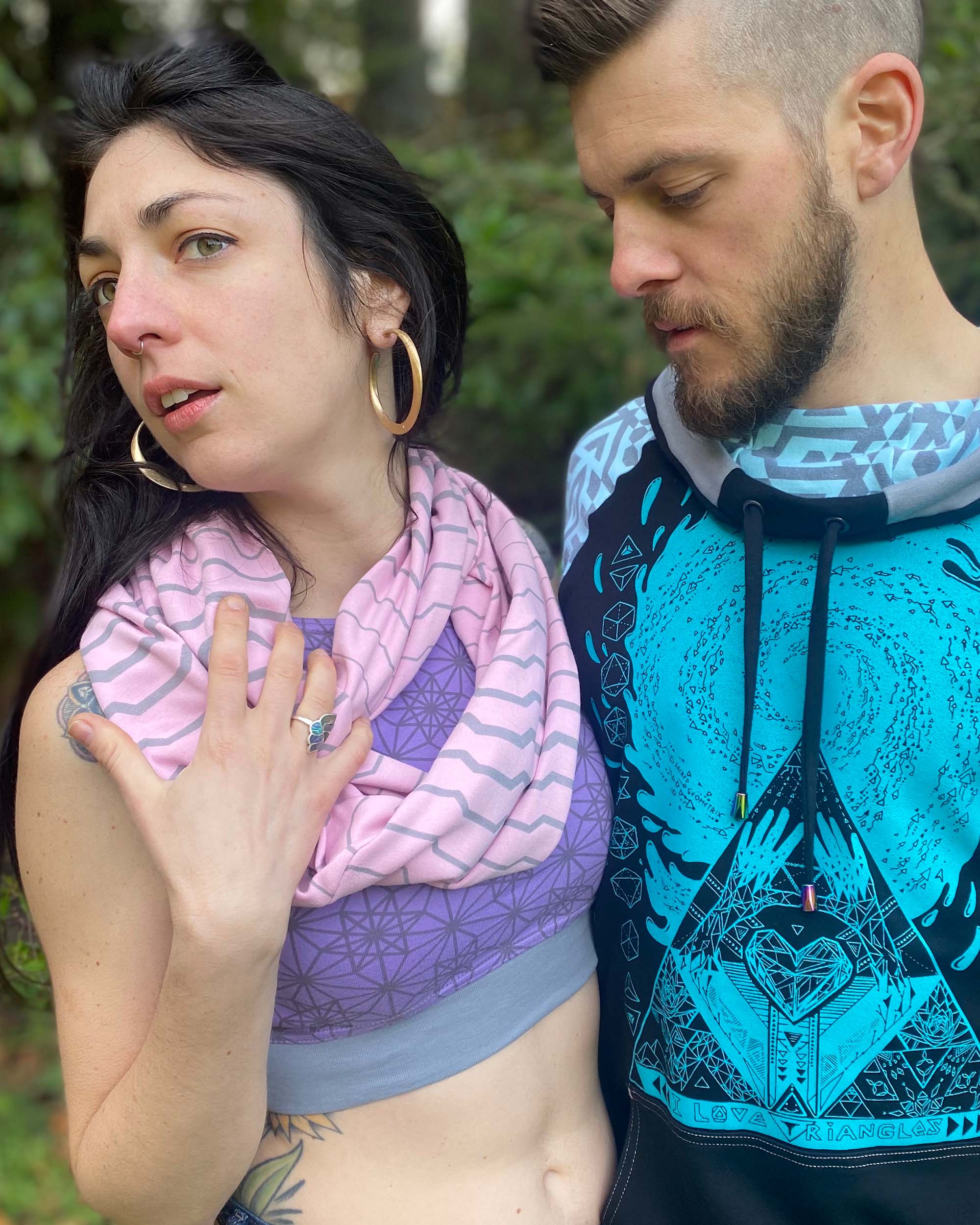 Pink organic cotton scarf with geometric stripes, front view on female model.