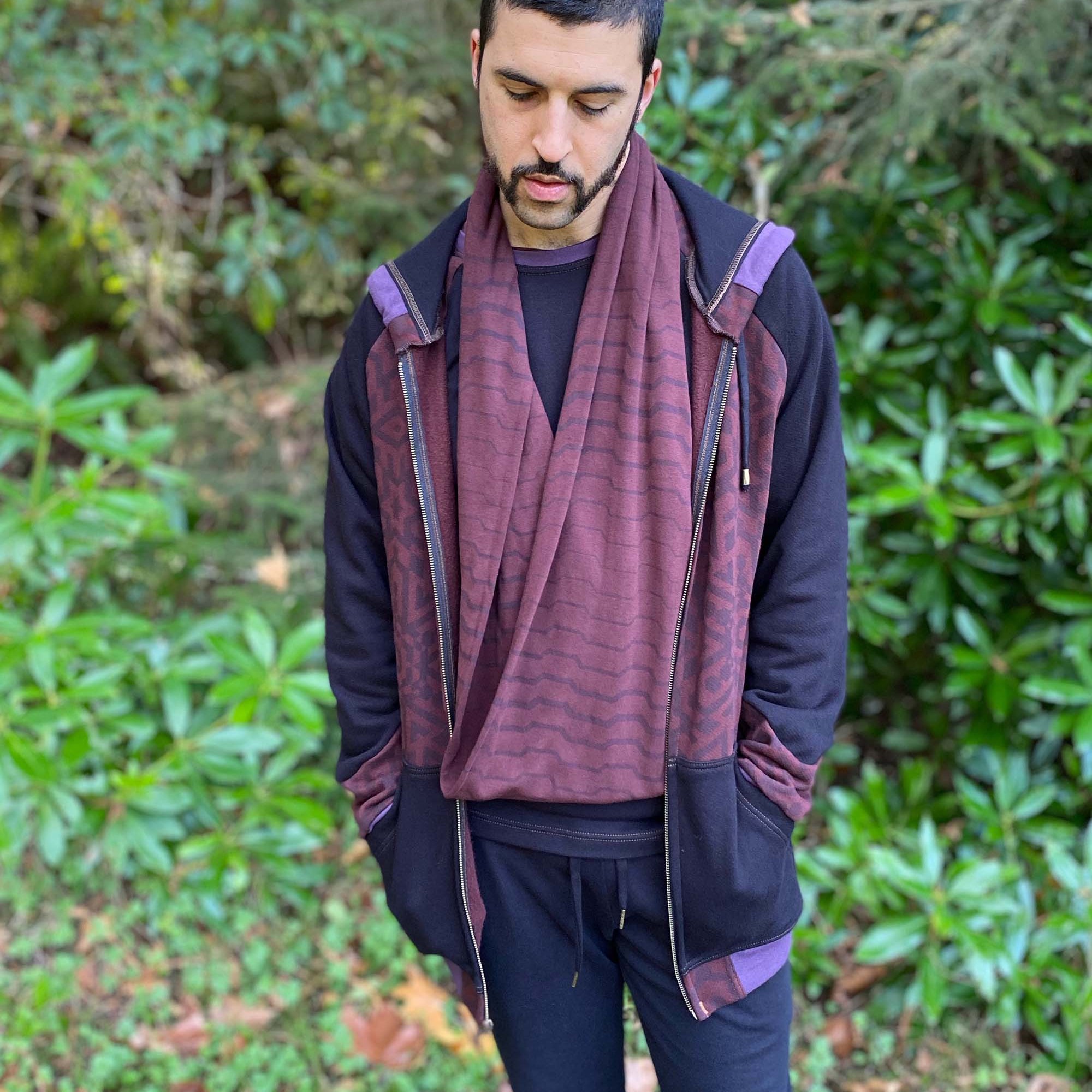 Organic cotton infinity scarf, brown fabric with geometric stripes, front view on male model.