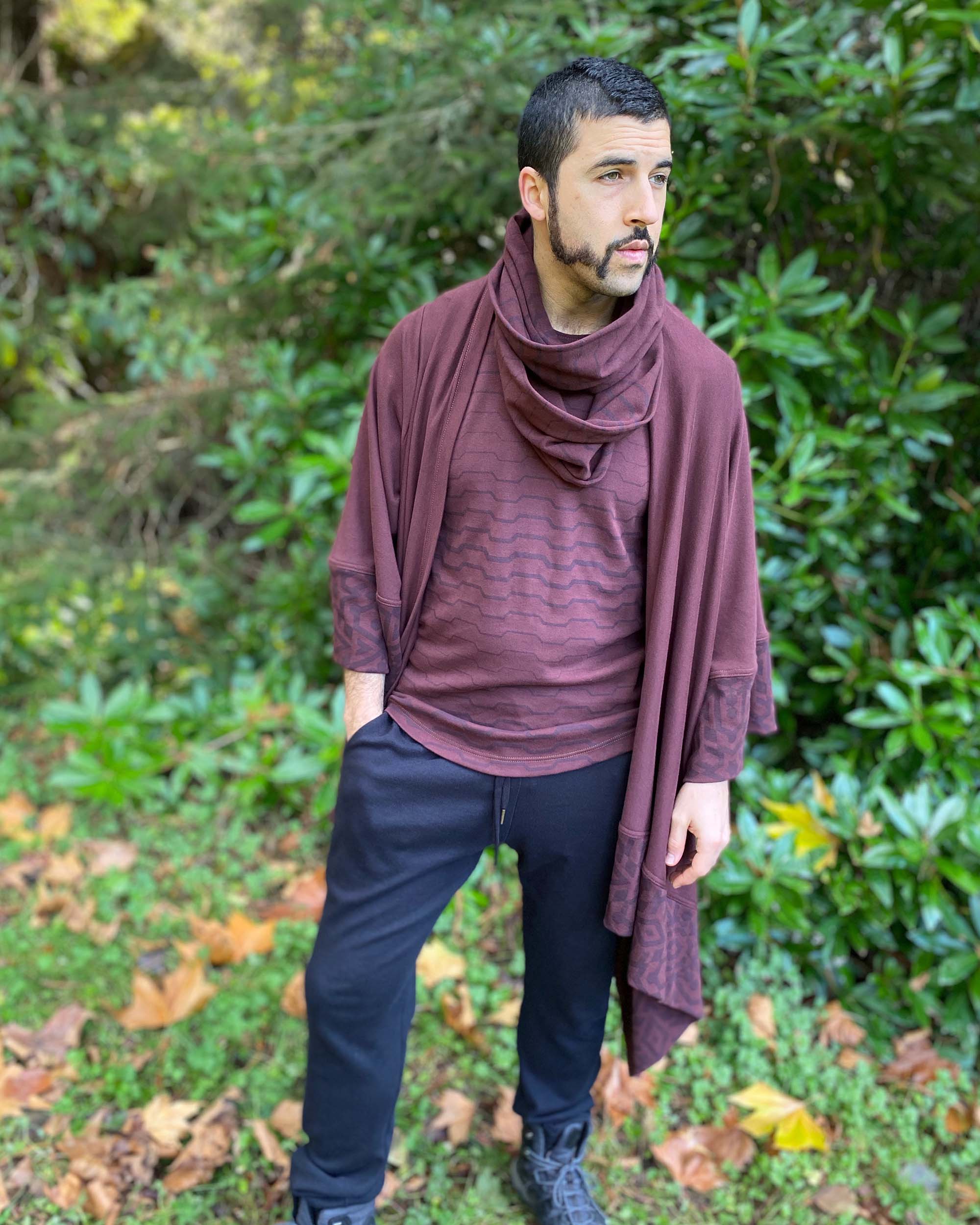 Organic cotton infinity scarf, brown fabric with geometric stripes, front view on male model with matching outfit.