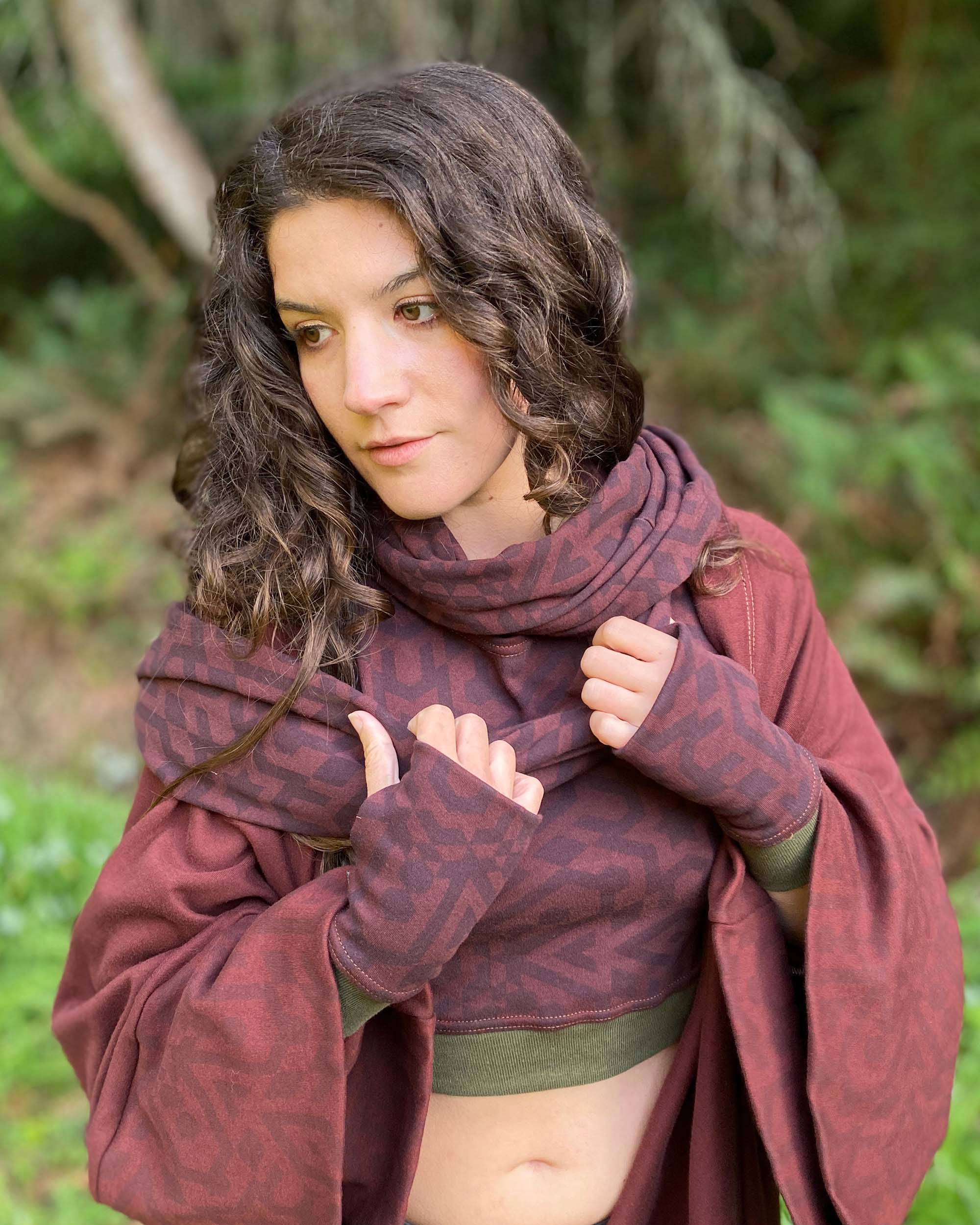Organic cotton infinity scarf, brown fabric with sacred geometry print, front view on female model.