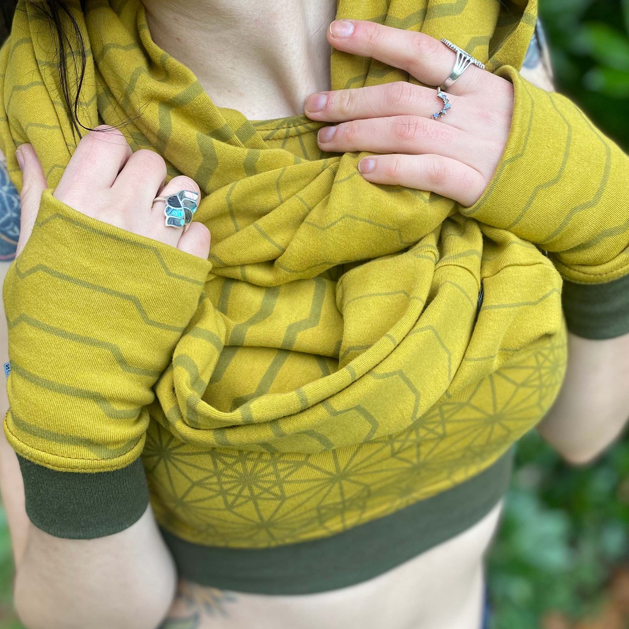 Organic cotton infinity scarf and hand warmers, yellow fabric with geometric stripes, detail view of fabric prints.