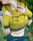Female model wearing matching set of crop top, infinity scarf and fingerless gloves, yellow organic cotton fabric with geometric stripes, detail view.