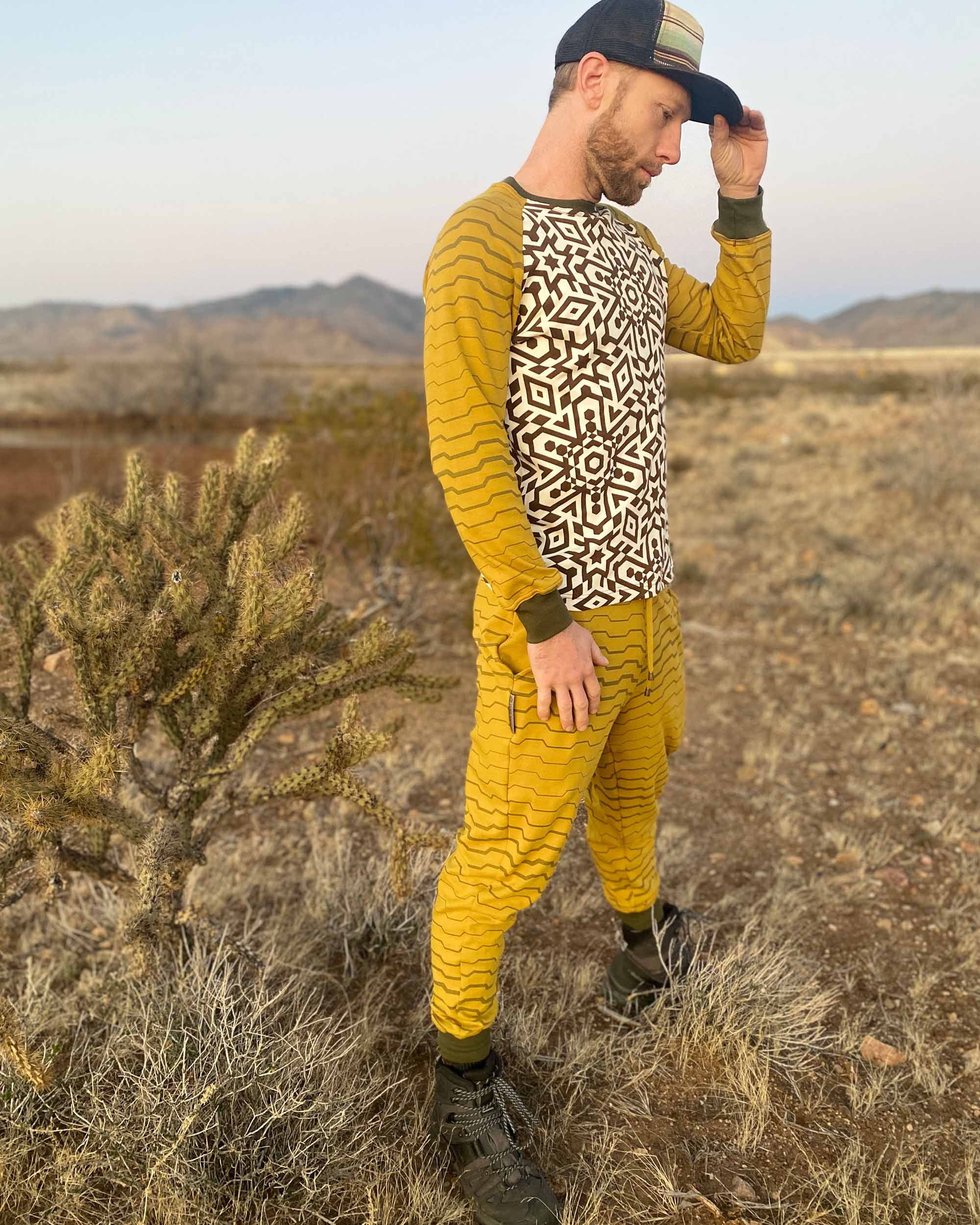 Men's matching joggers and long sleeve shirt, yellow with geometric stripe accents, side view worn by male model.