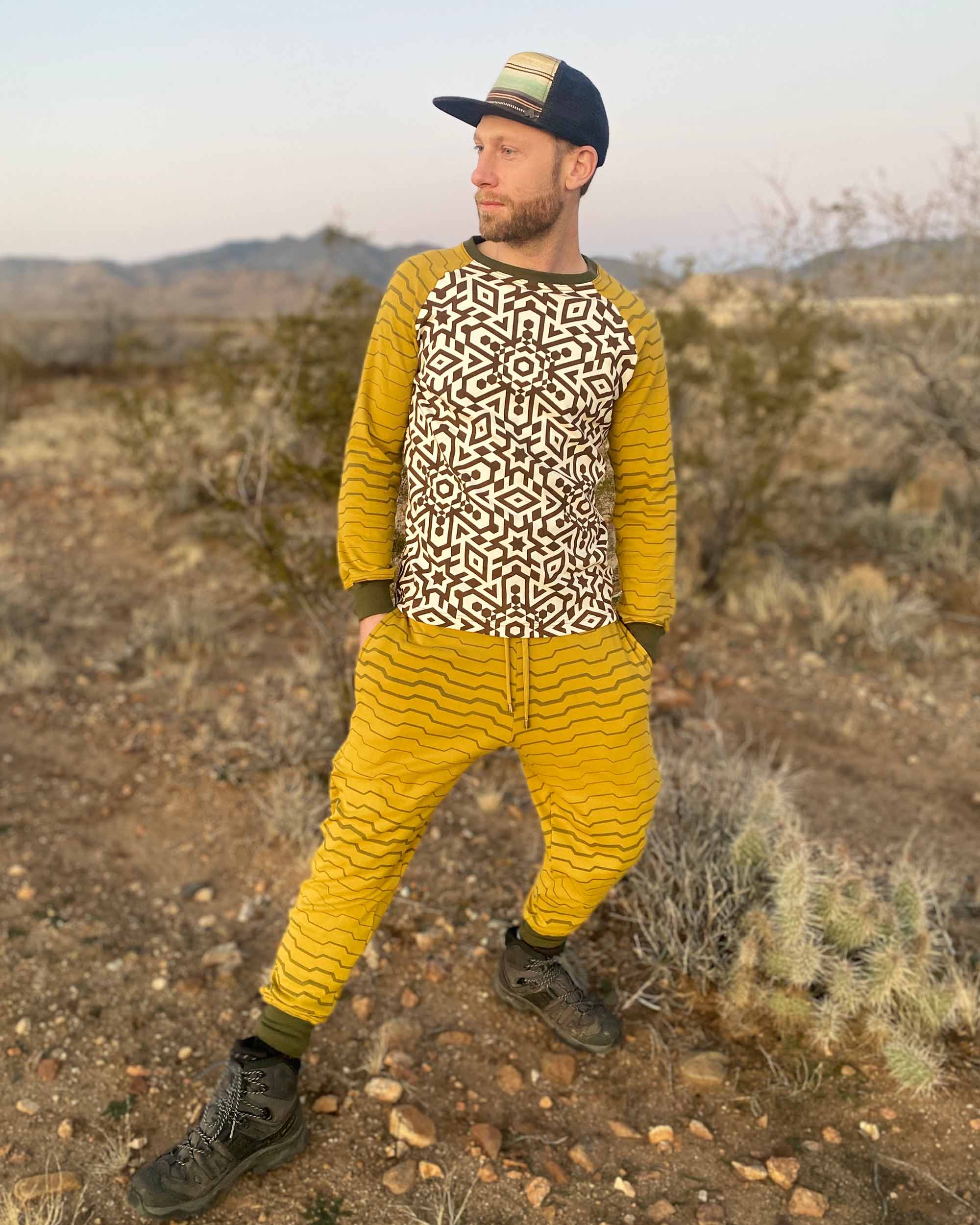 Men's matching joggers and long sleeve shirt, yellow with geometric stripe accents, front view on male model.