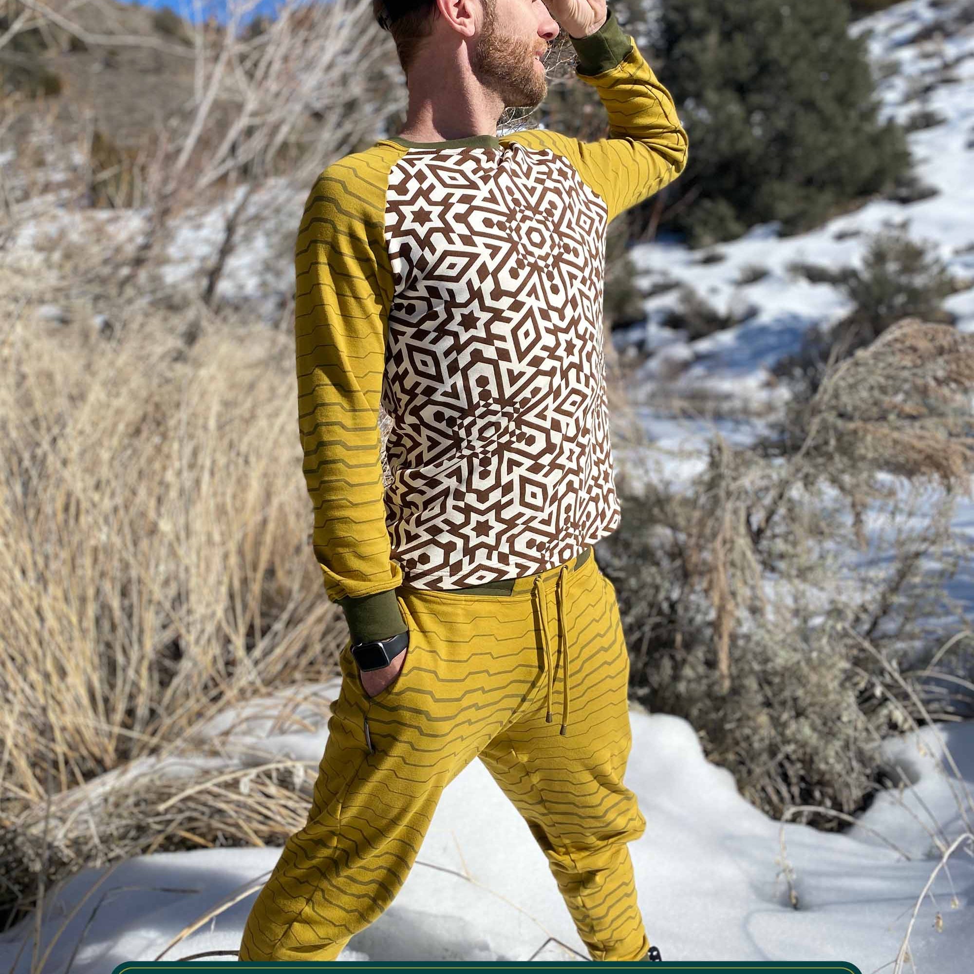 Men's matching 2 piece set, joggers and long sleeve shirt, yellow with geometric stripe accents, front right side view on model.