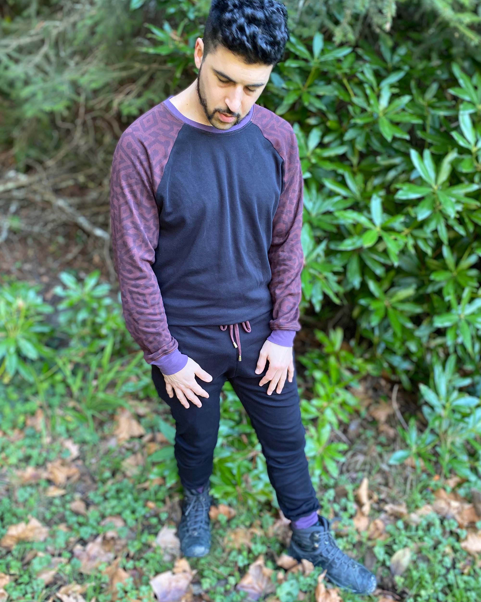 Men's 2 piece matching set, joggers and long sleeve shirt, black with brown accents, front right side view on model.