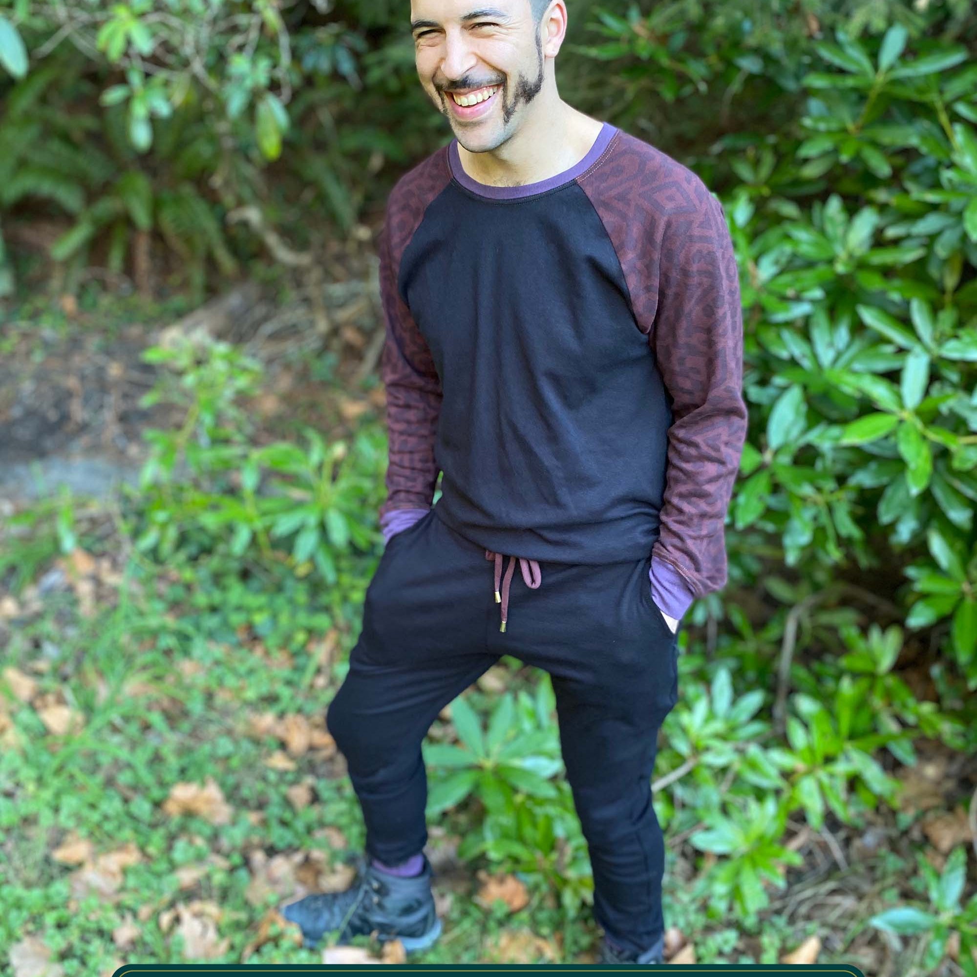 Men's 2 piece matching set, joggers and long sleeve shirt, black with brown accents, front view on model.