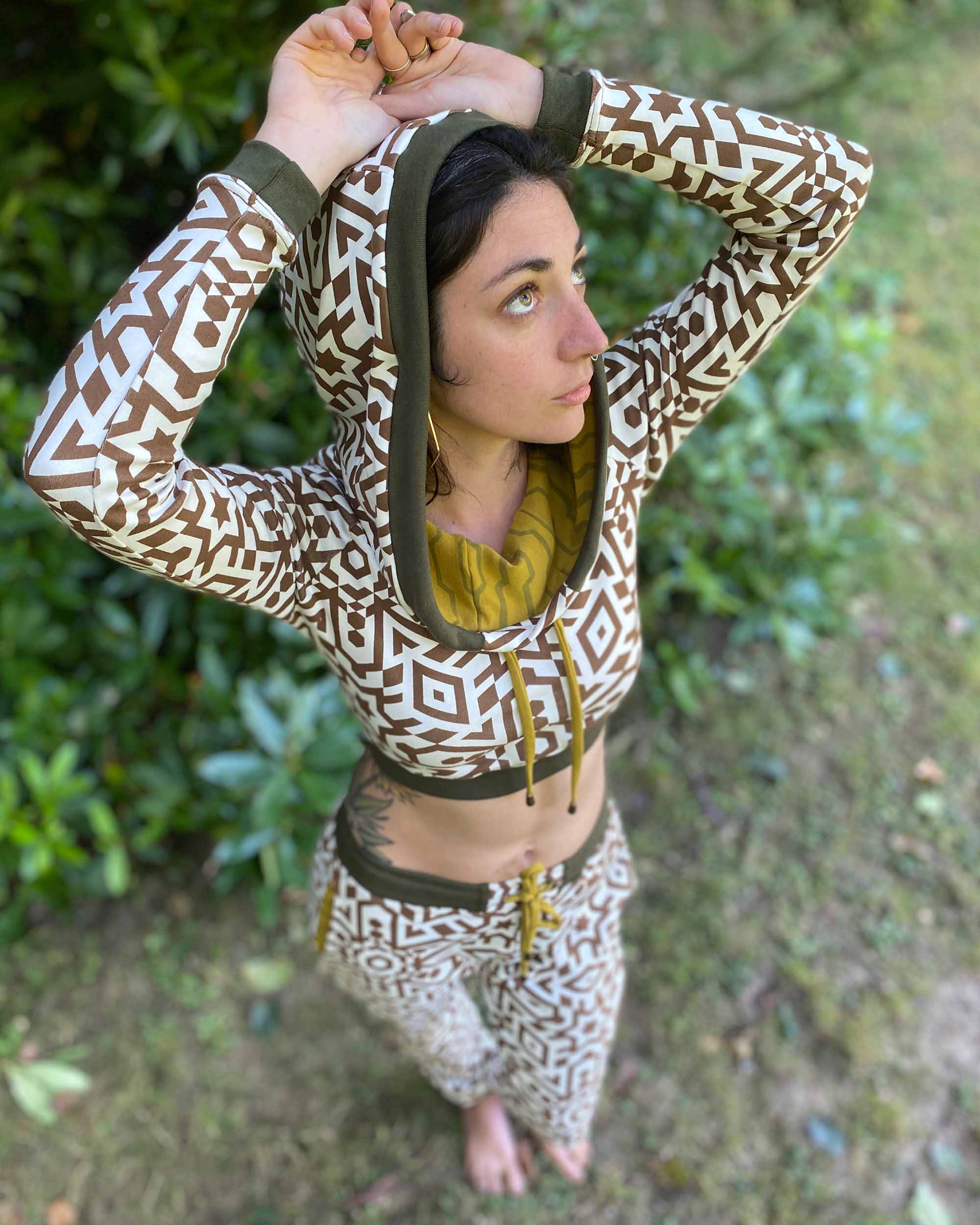 Women's matching two piece set, joggers and crop hoodie, undyed with brown geometric print, Top view on model.